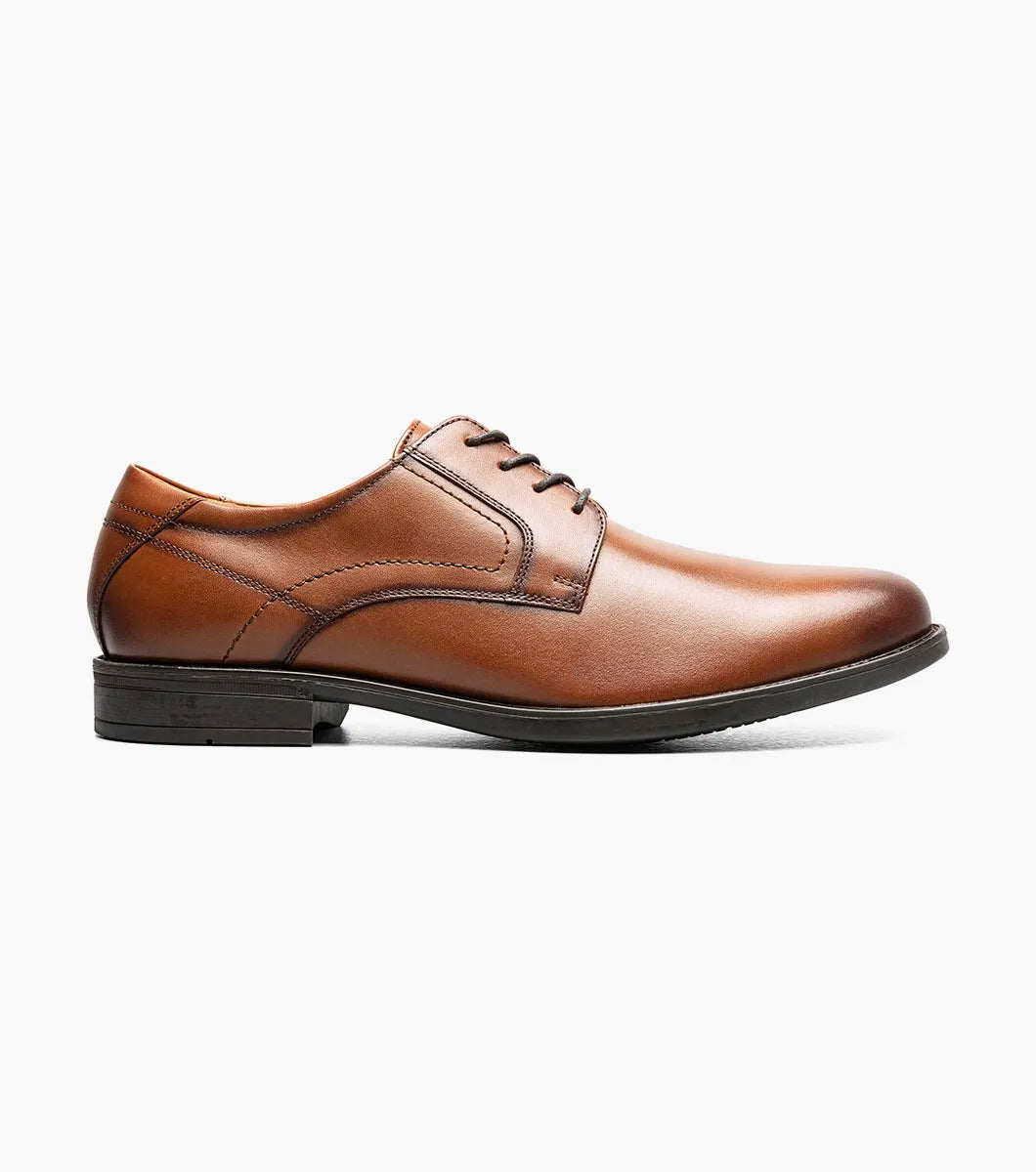 Brown leather dress shoe on a white background