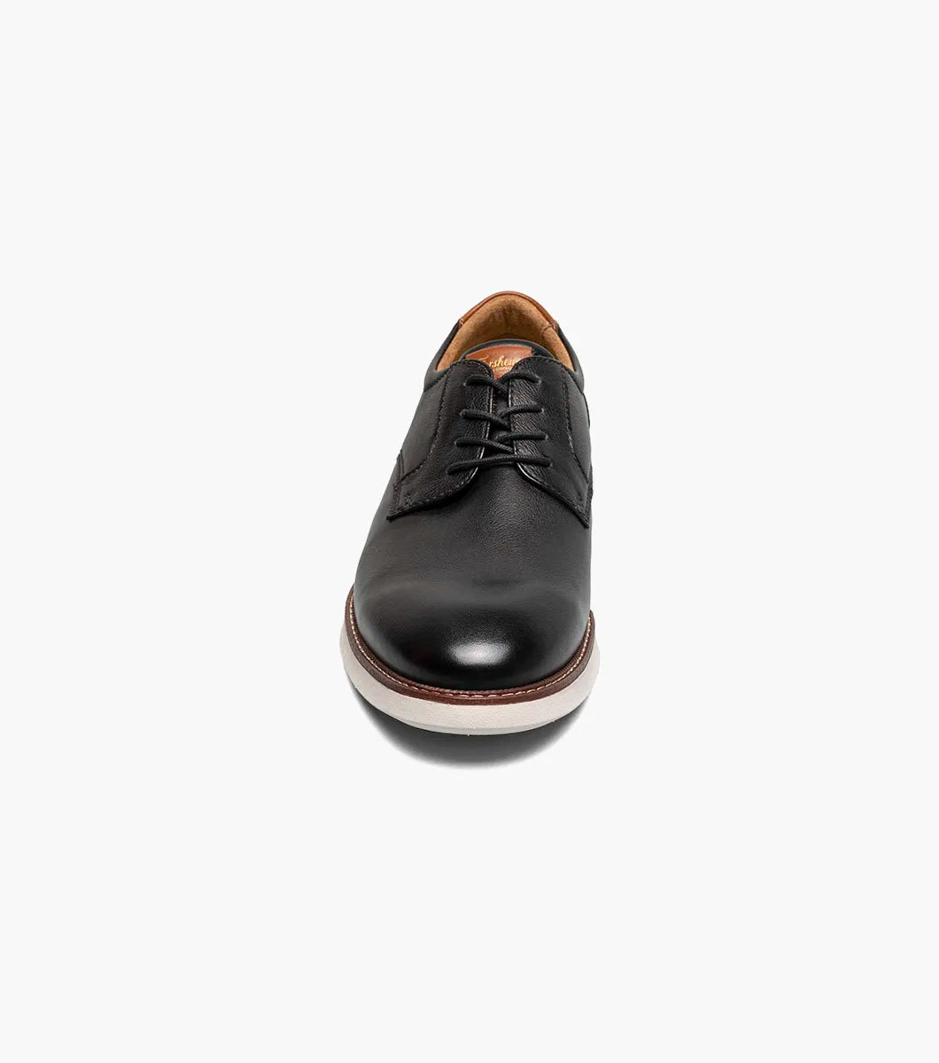 Black leather dress shoe on a white background