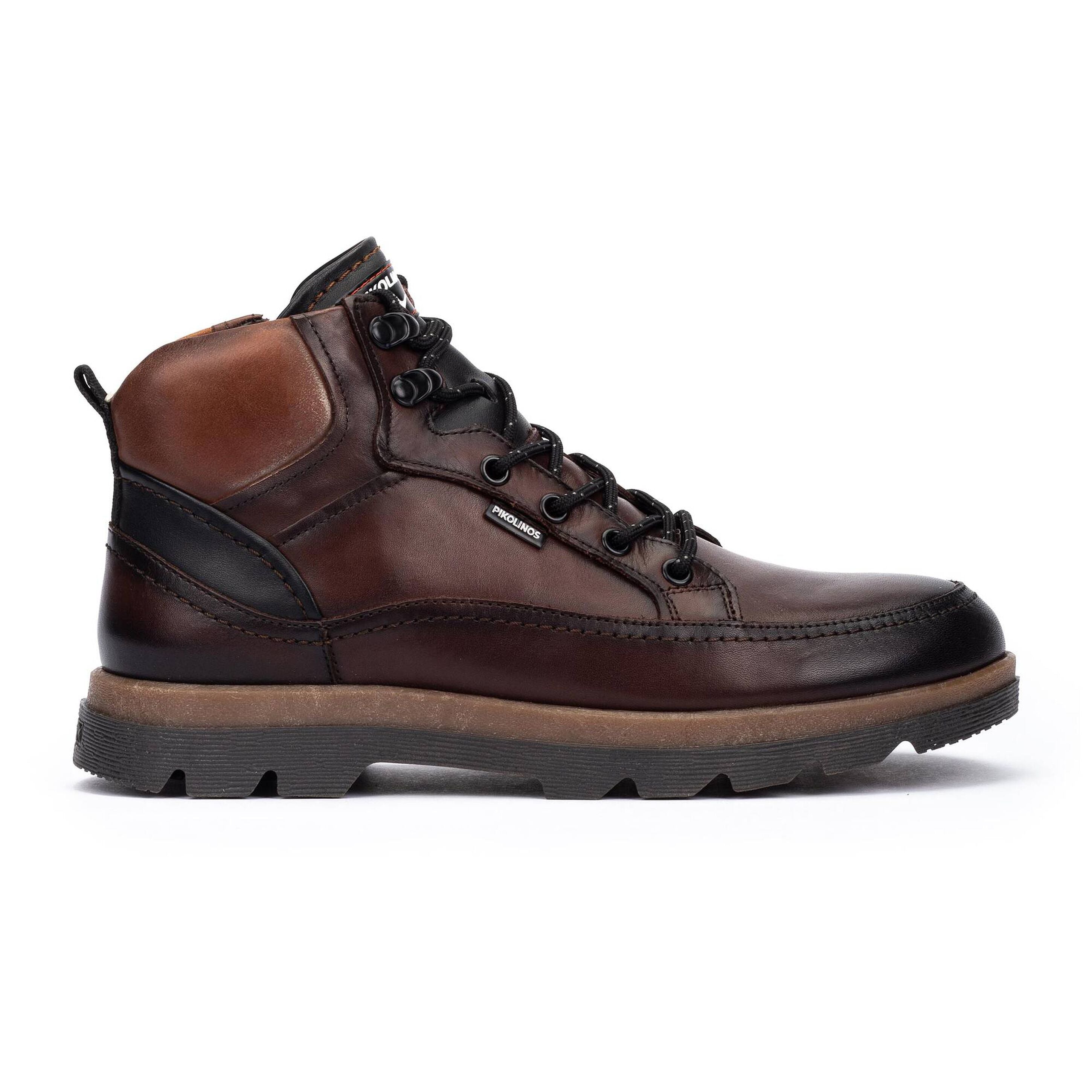 Black hiking boot with brand logo on a white background