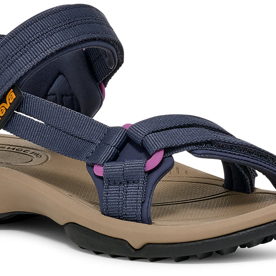 Navy blue sandal with beige sole on a white background