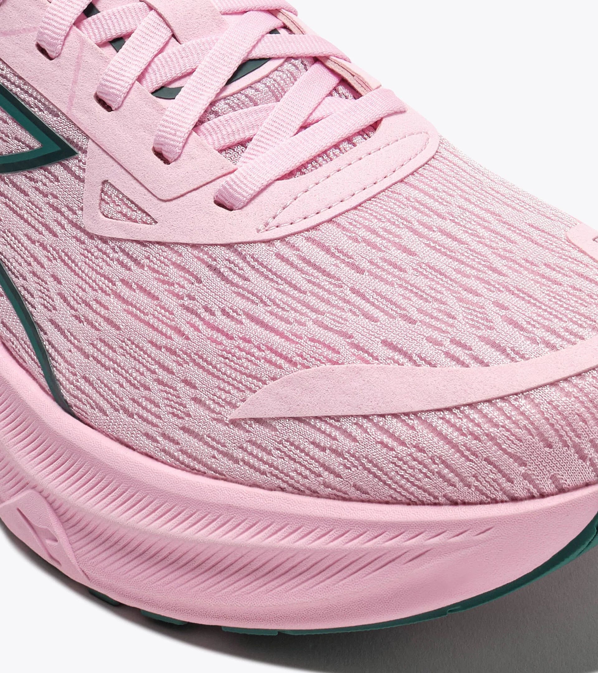 Close-up of a pink running shoe with a focus on the sole and texture.