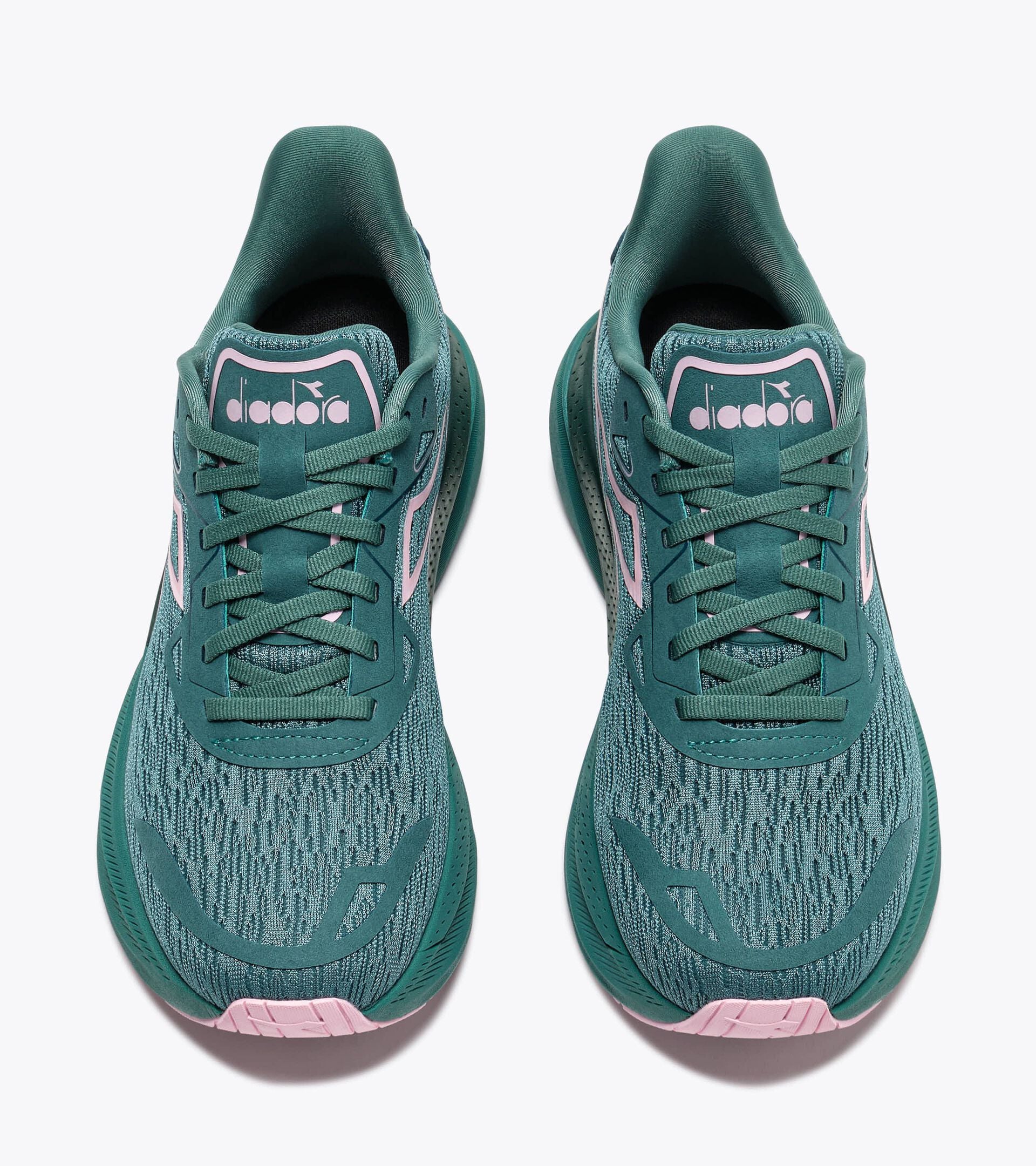 Teal running shoes with pink accents on a white background