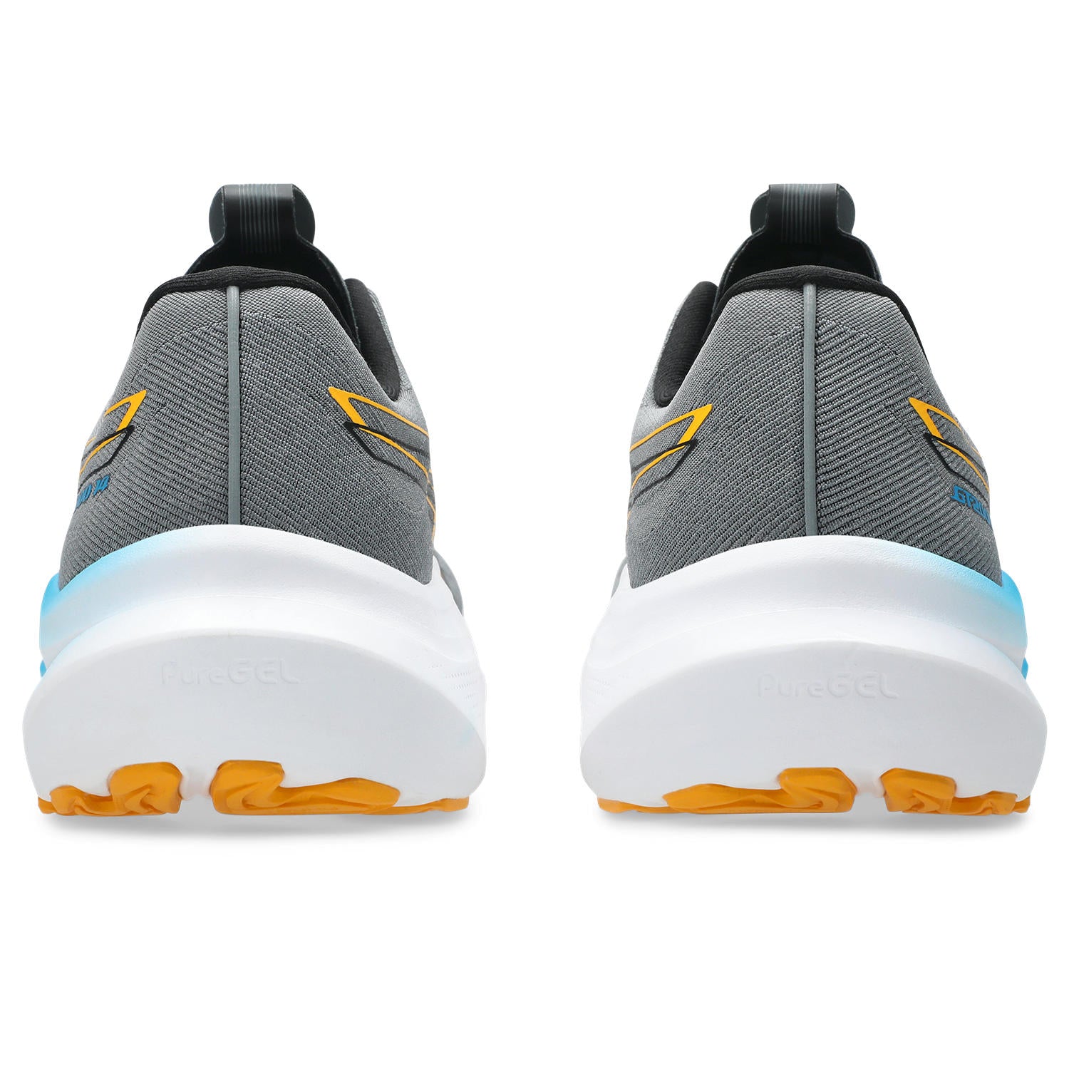 Gray and yellow running shoes with white soles on a white background