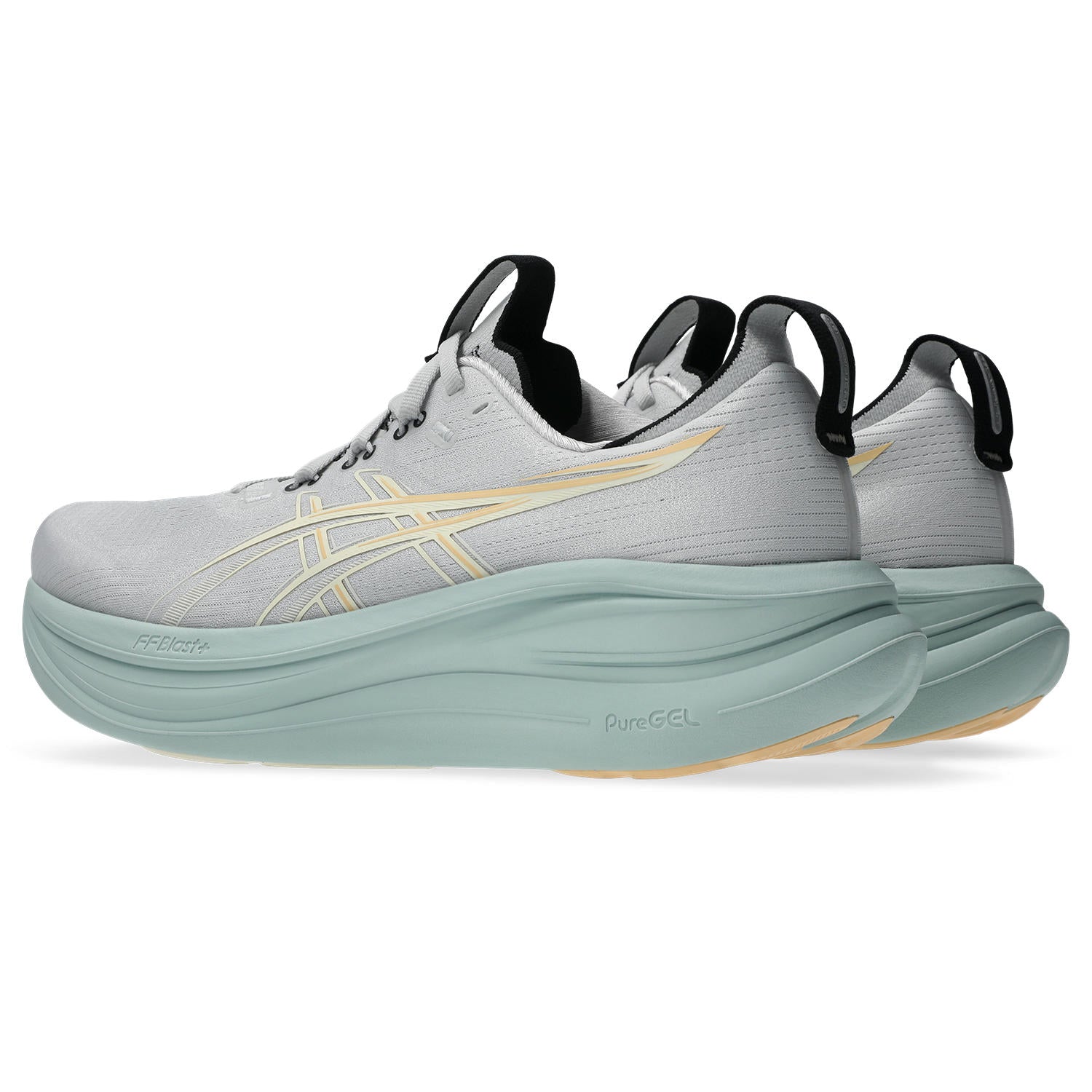 Gray running shoe with green sole on a white background