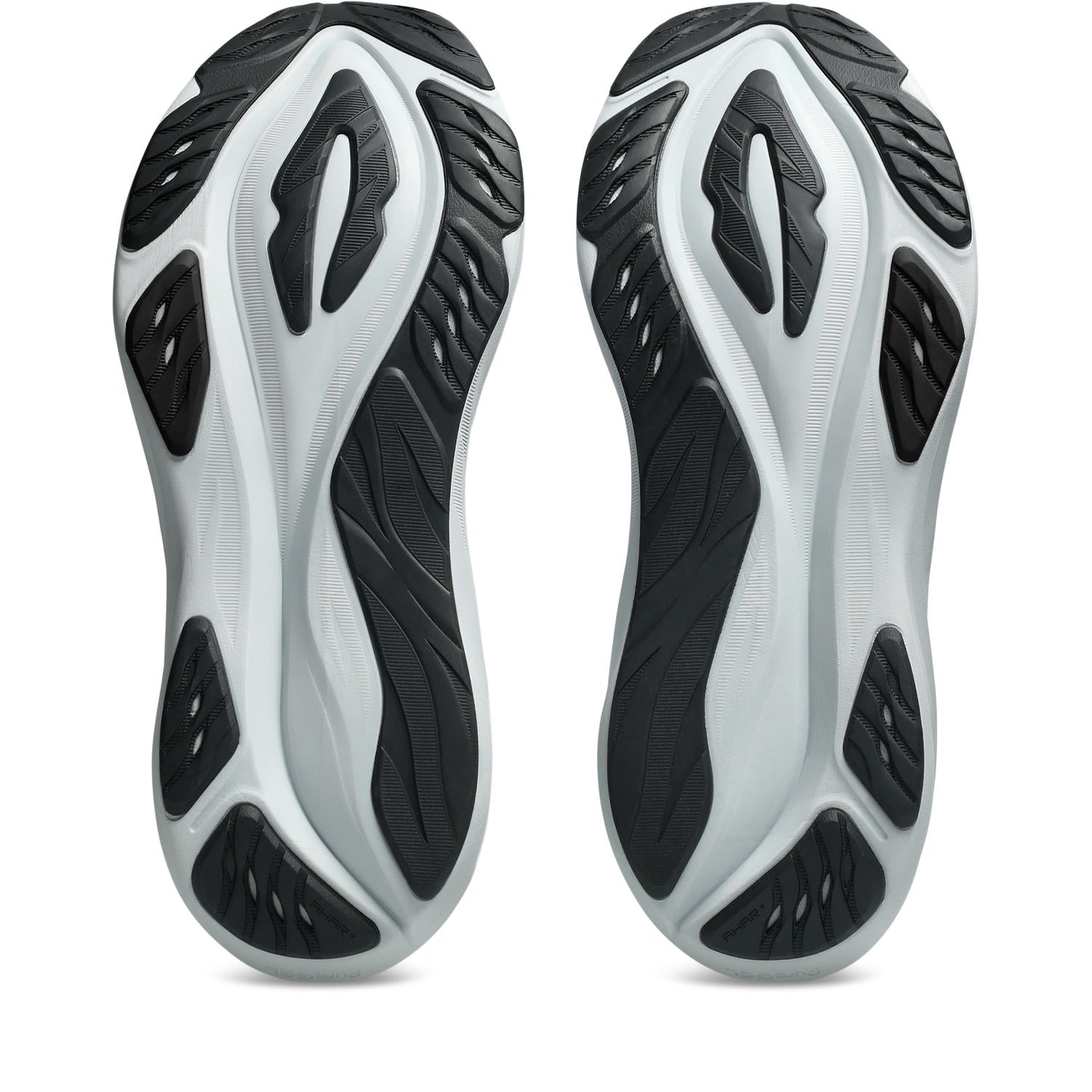 A pair of athletic shoes shown from the sole view, featuring a chunky, sculpted midsole in white and black with textured rubber outsoles.