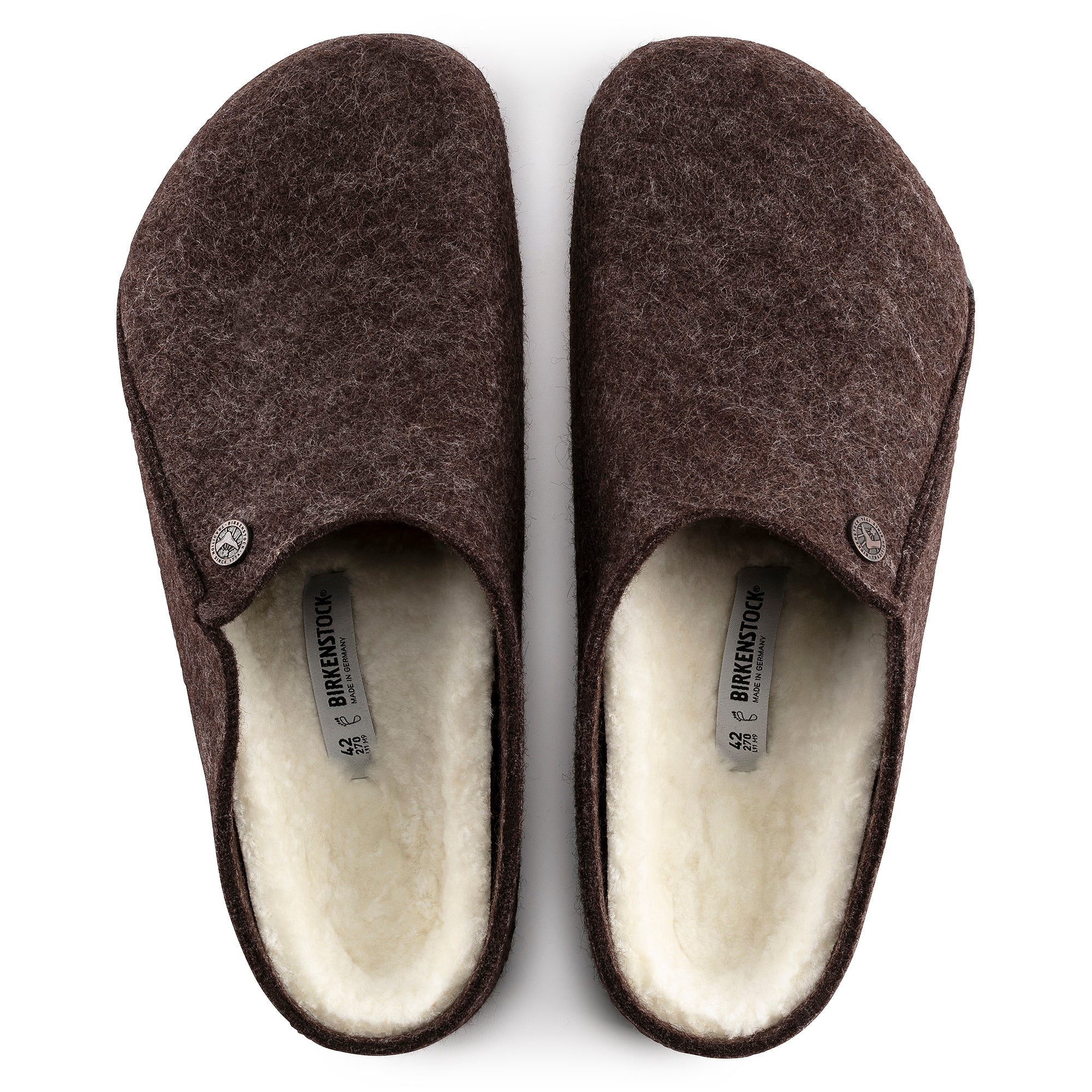 Pair of brown slippers with white lining on a white background