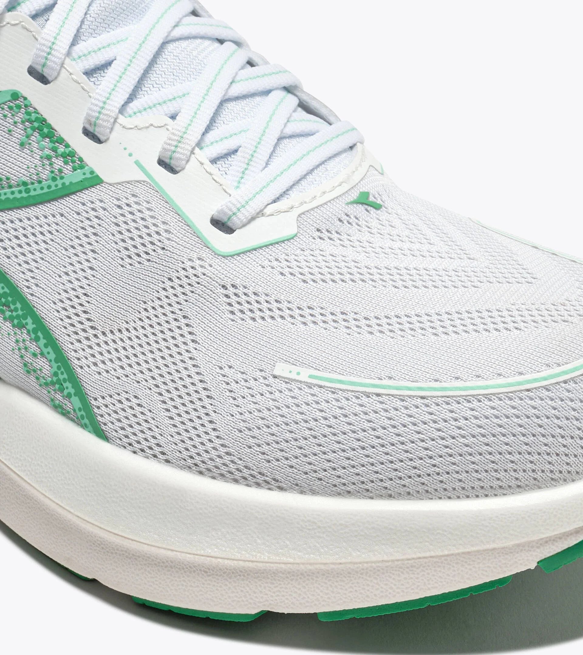 Gray athletic shoe with green accents on a white background