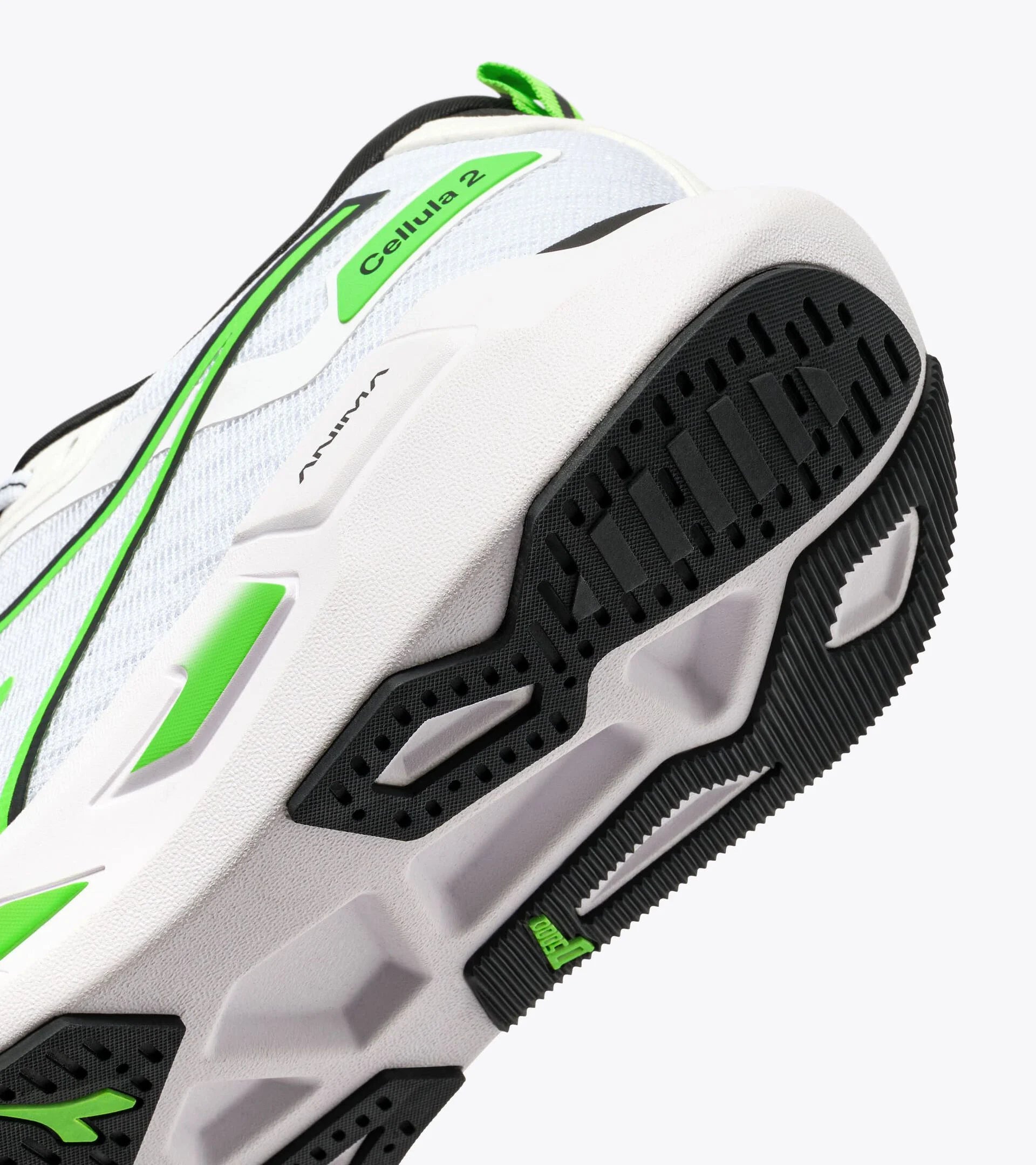 Close-up of a white athletic shoe with green accents on a white background