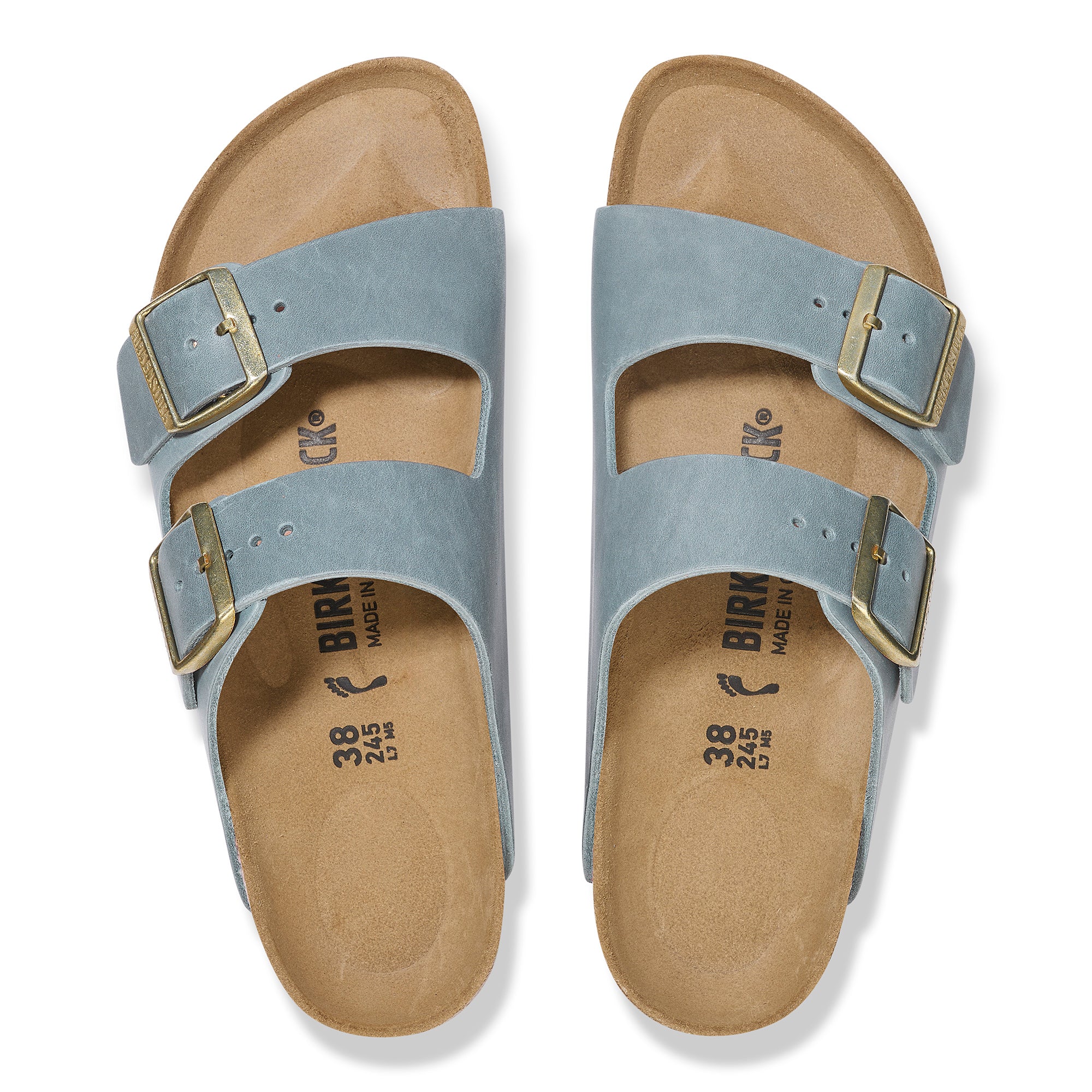 Pair of light blue sandals with gold buckles on a white background
