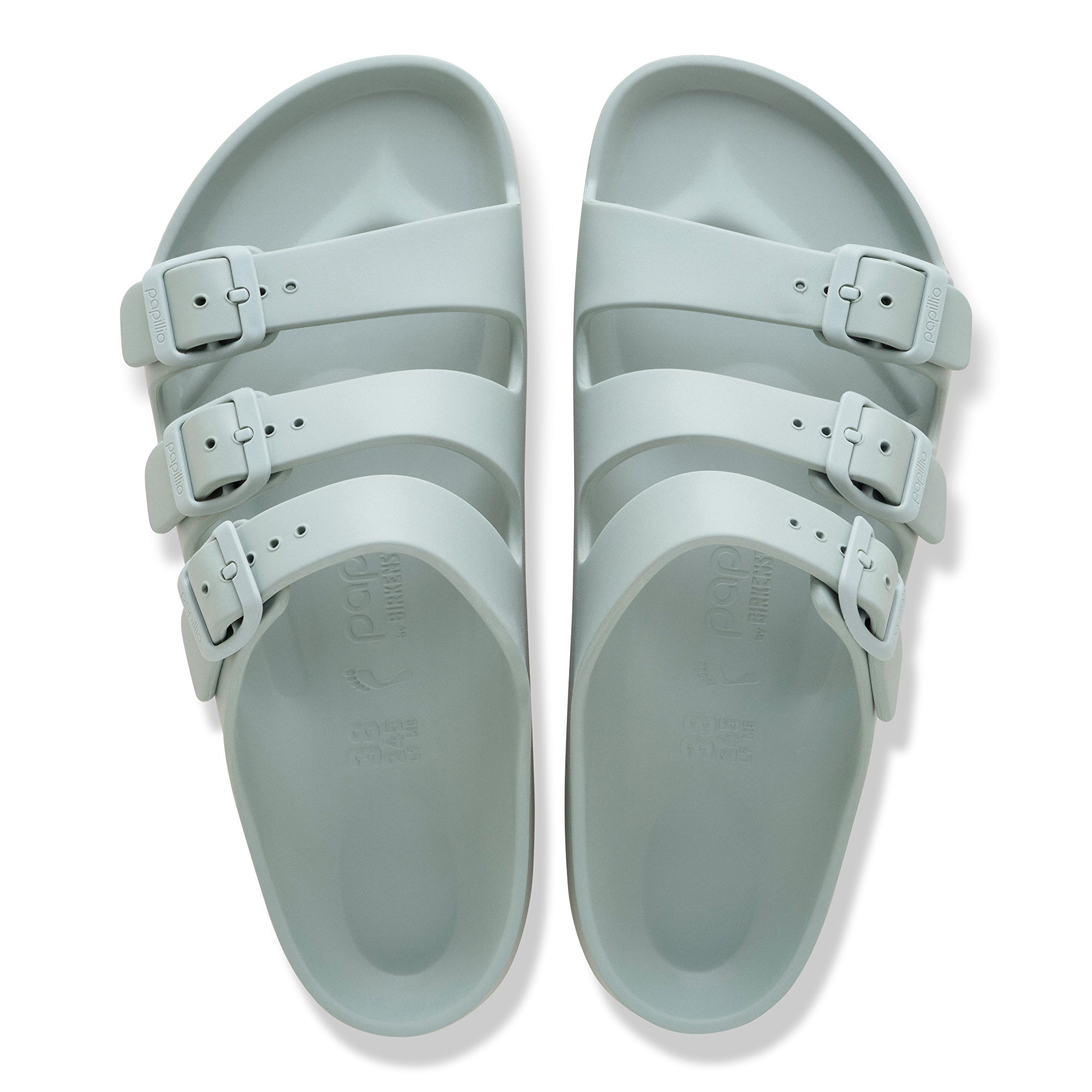 Pair of light blue sandals with multiple straps on a white background