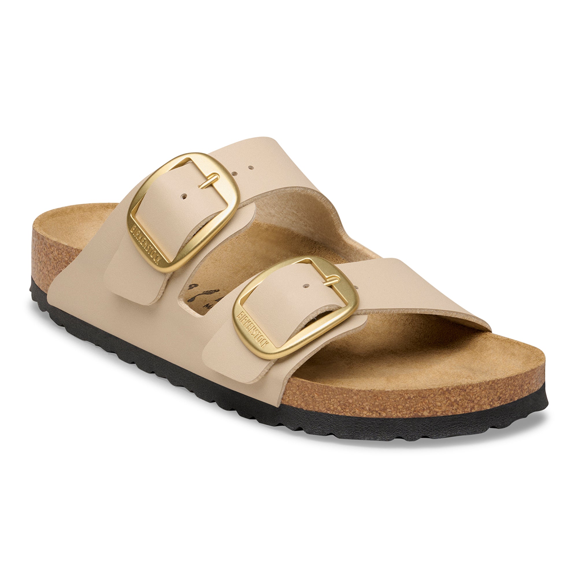 Beige sandal with gold buckles on a white background