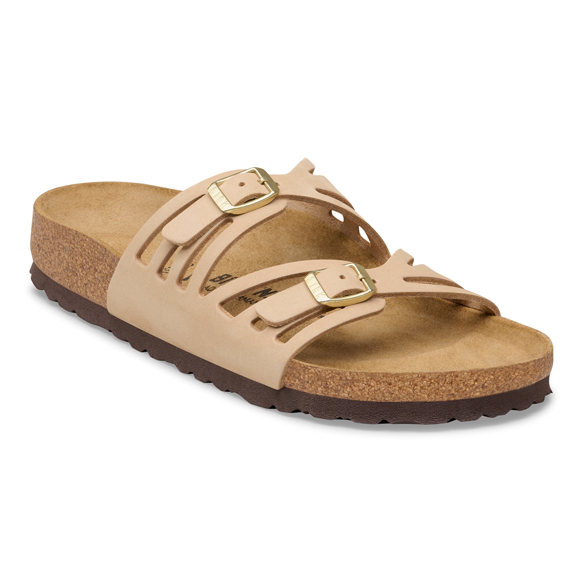 Beige sandal with gold buckles on a white background