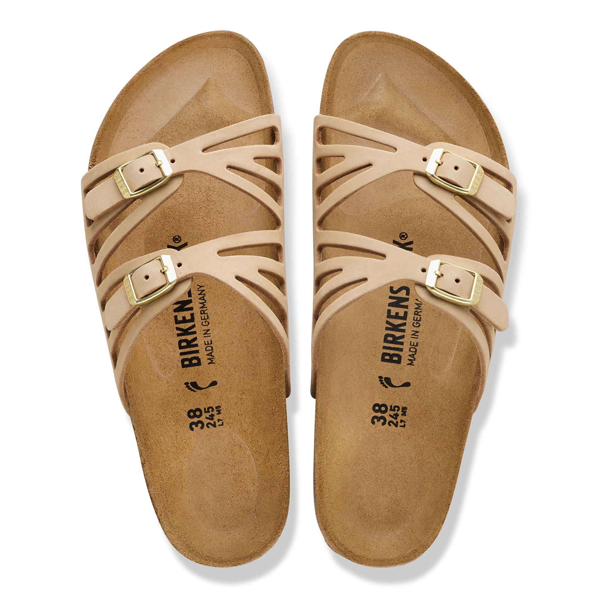 Pair of tan sandals with gold buckles on a white background