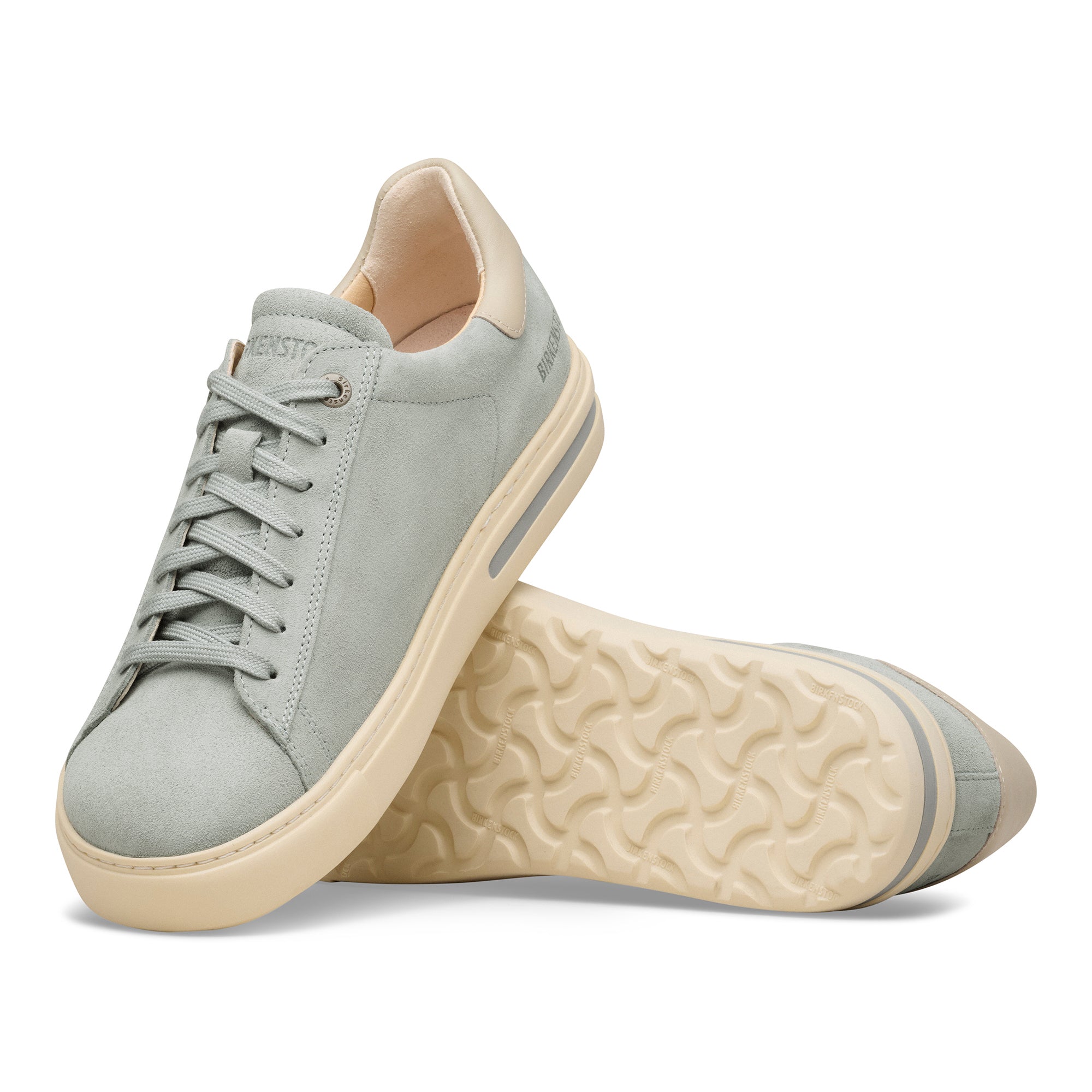 Pair of light gray sneakers with beige soles on a white background