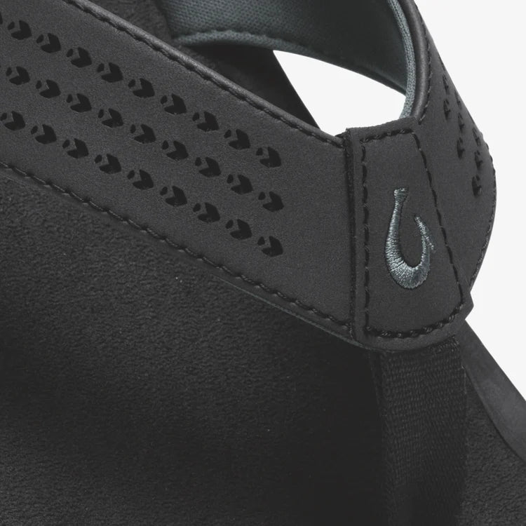 Close-up of a black visor with a brand logo on a white background