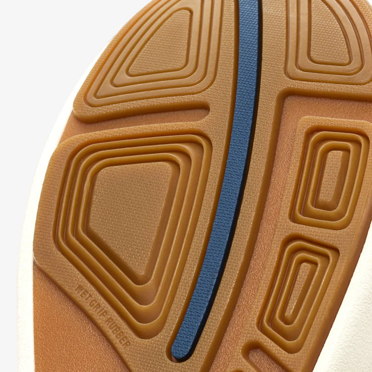 Close-up of a brown shoe sole with a blue line on a white background