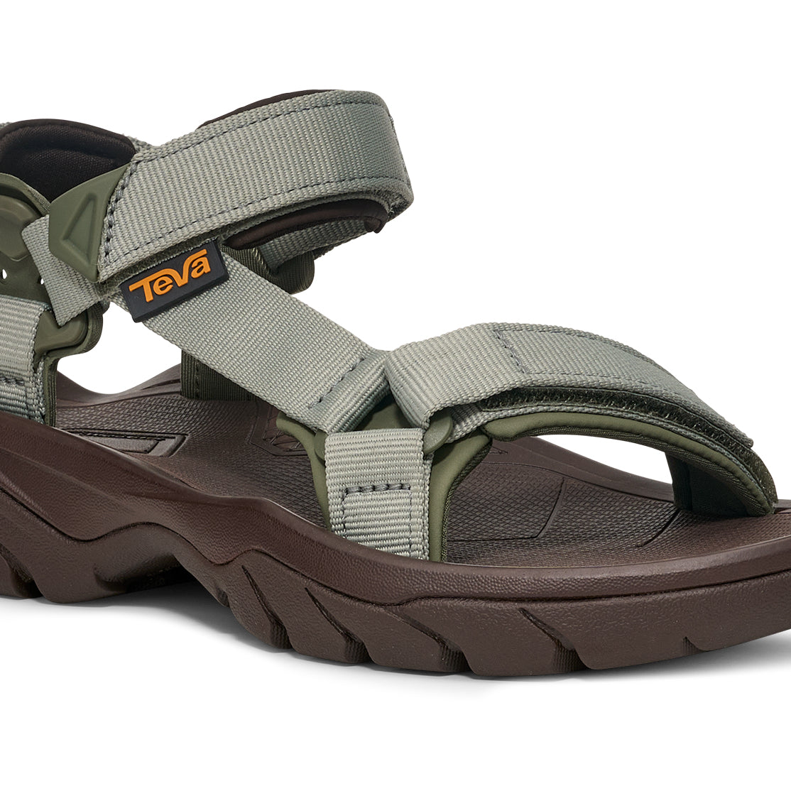 Green sandal with brown sole on a white background