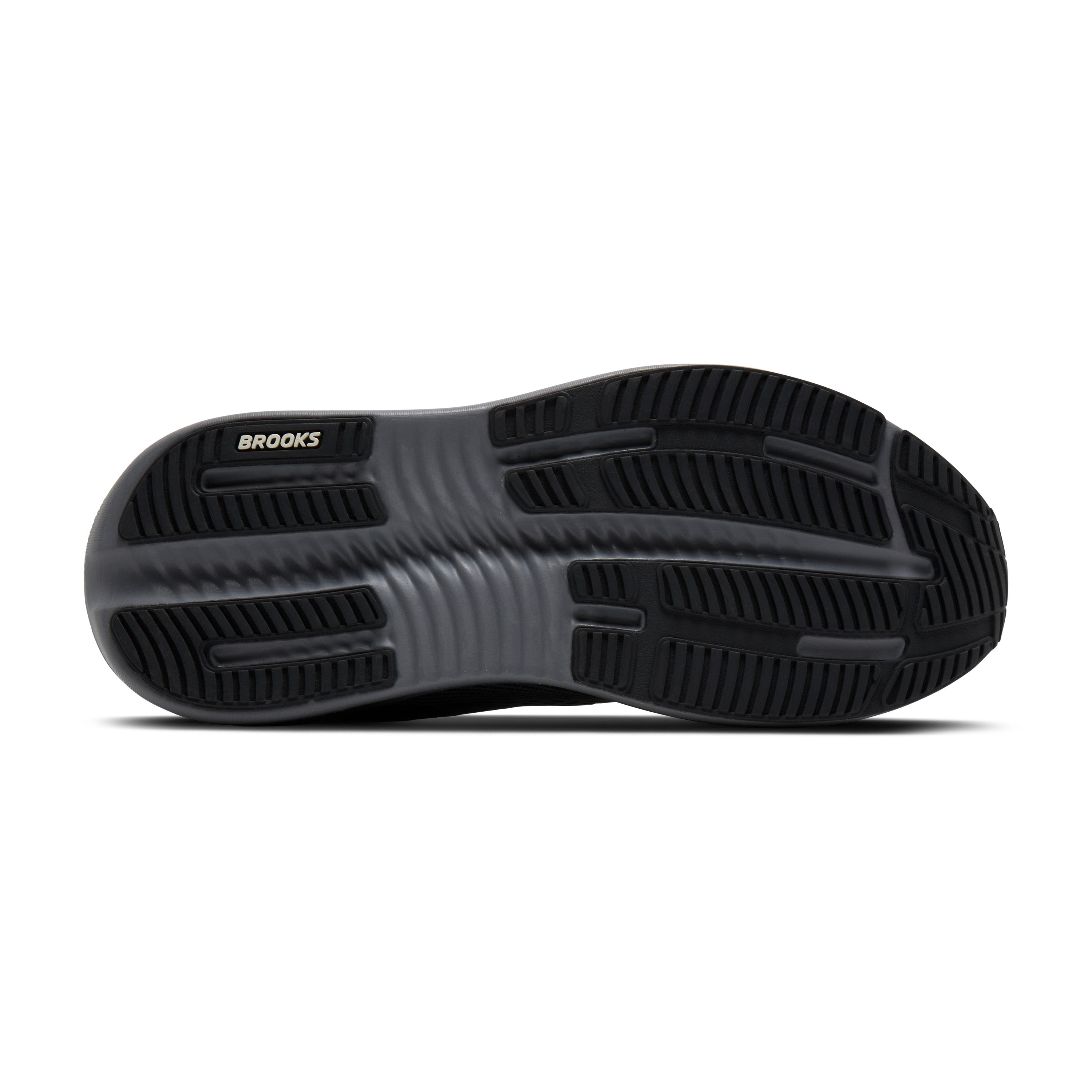 The black rubber outsole of a Brooks shoe, showing the textured tread pattern and the white BROOKS logo on the heel, set against a plain white background.