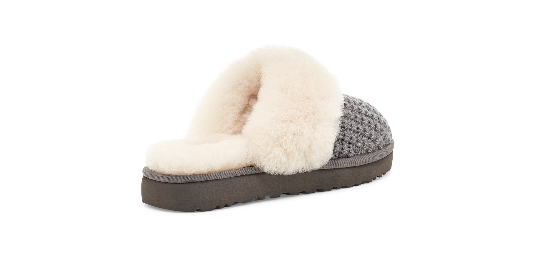 A single slip-on mule slipper shown from the side on a plain white background. The upper features a cream-colored fluffy faux-fur trim over a gray and black houndstooth knit pattern, with a dark brown platform sole.