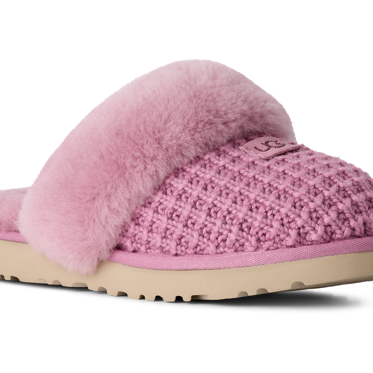 A pink knit slipper with fluffy pink faux-fur trim and a beige sole, shown from a side profile on a white background.