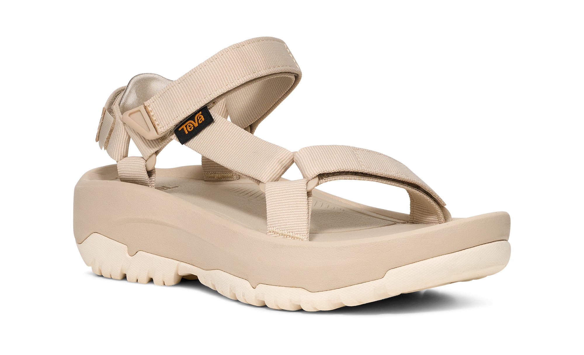 Beige sandal with 'Teva' branding on a white background