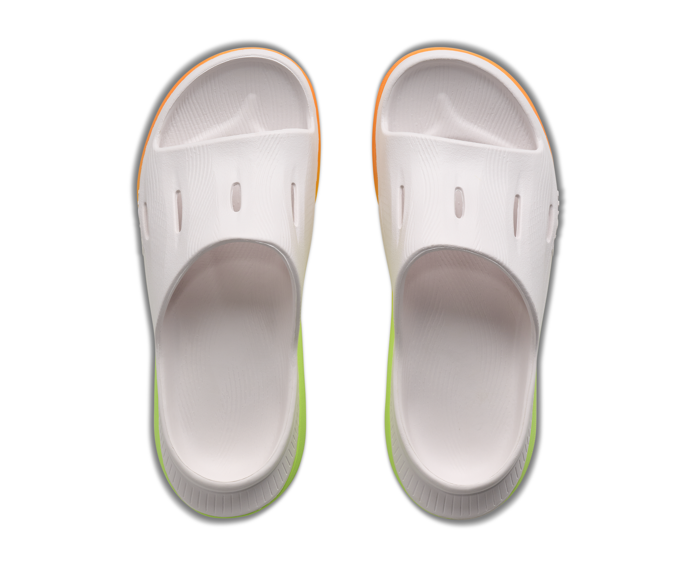 White clogs with orange and green accents on a white background