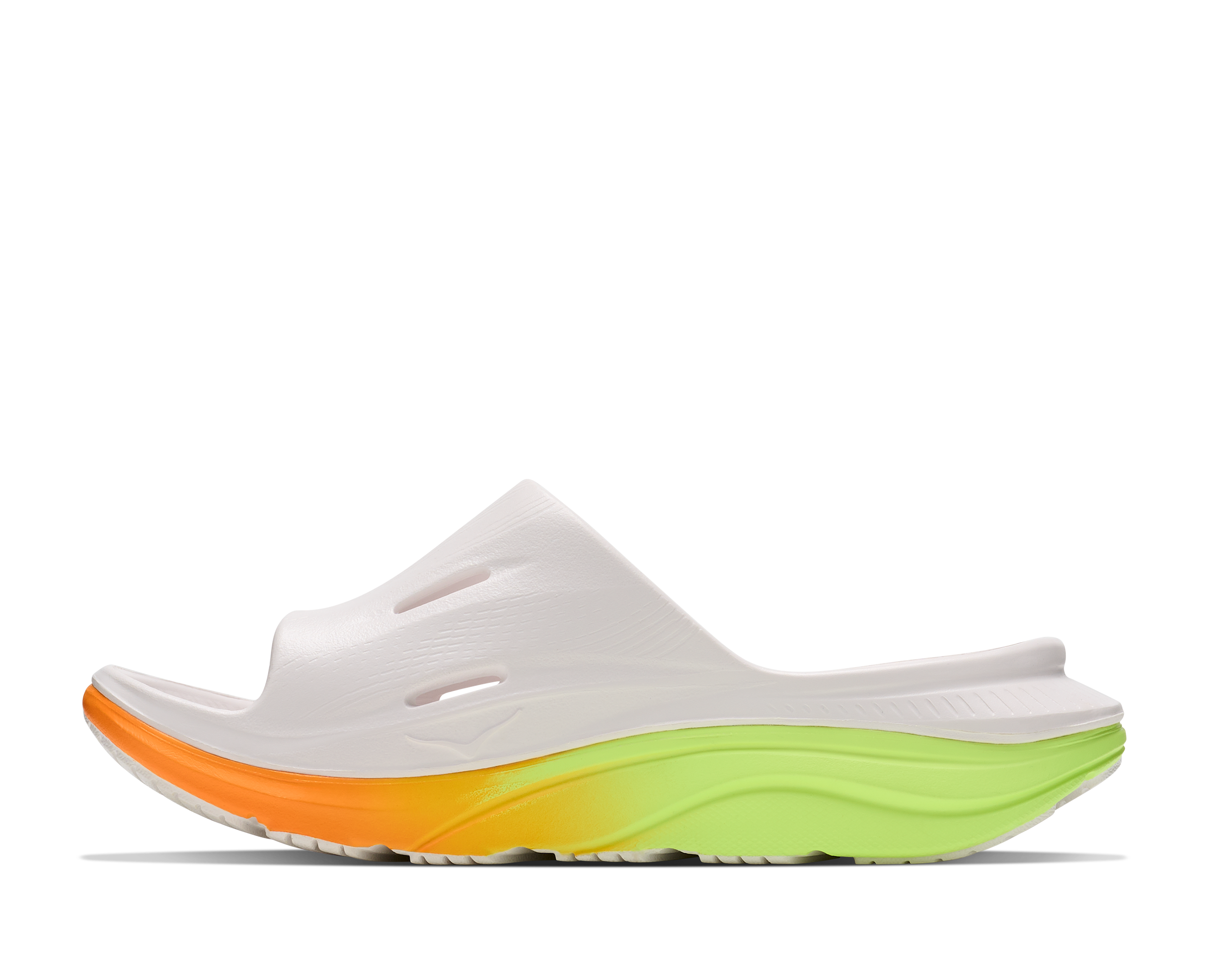 White slide sandal with orange and green sole on a white background