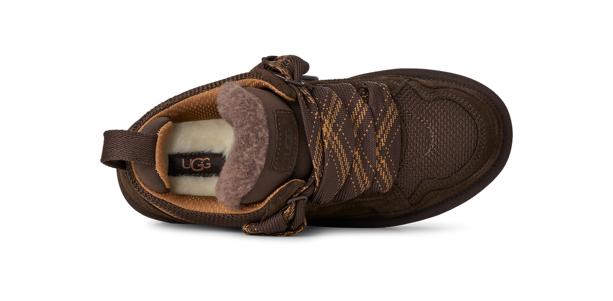 A single brown UGG lace-up bootie with a fuzzy brown shearling lining and patterned laces, shown from a side profile on a white background.