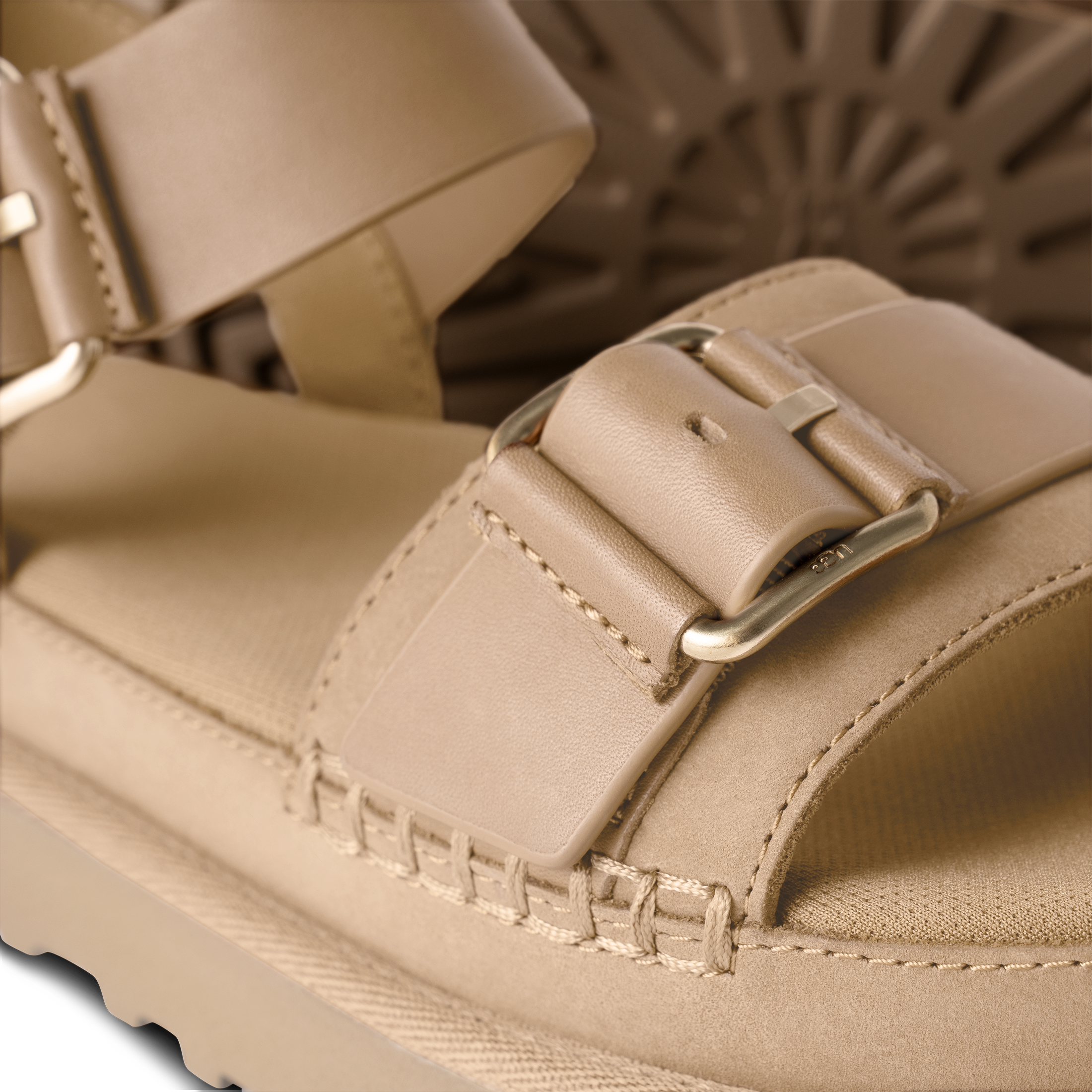 Close-up of a beige sandal with a buckle on a blurred background