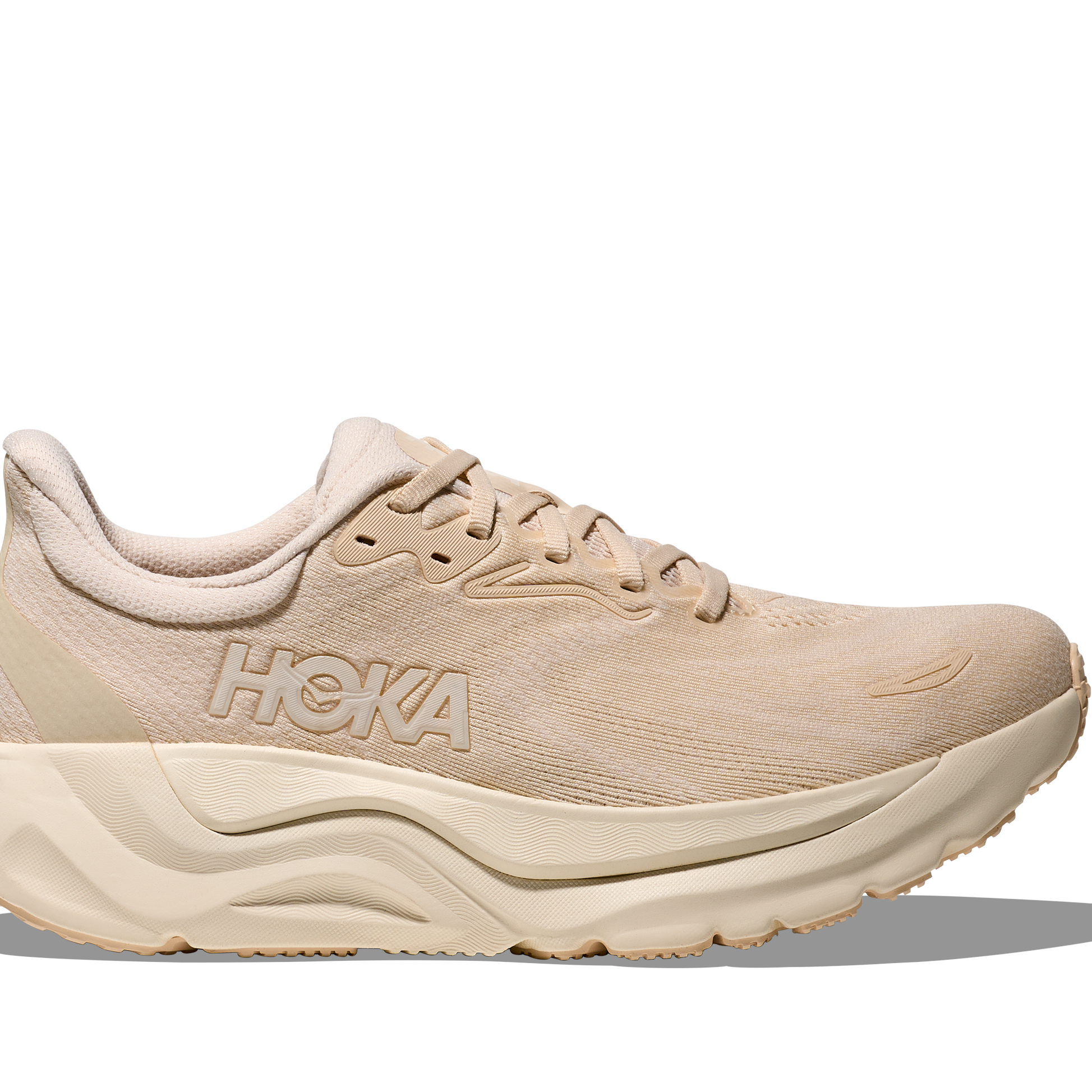 Beige running shoe with 'Hoka' branding on a white background
