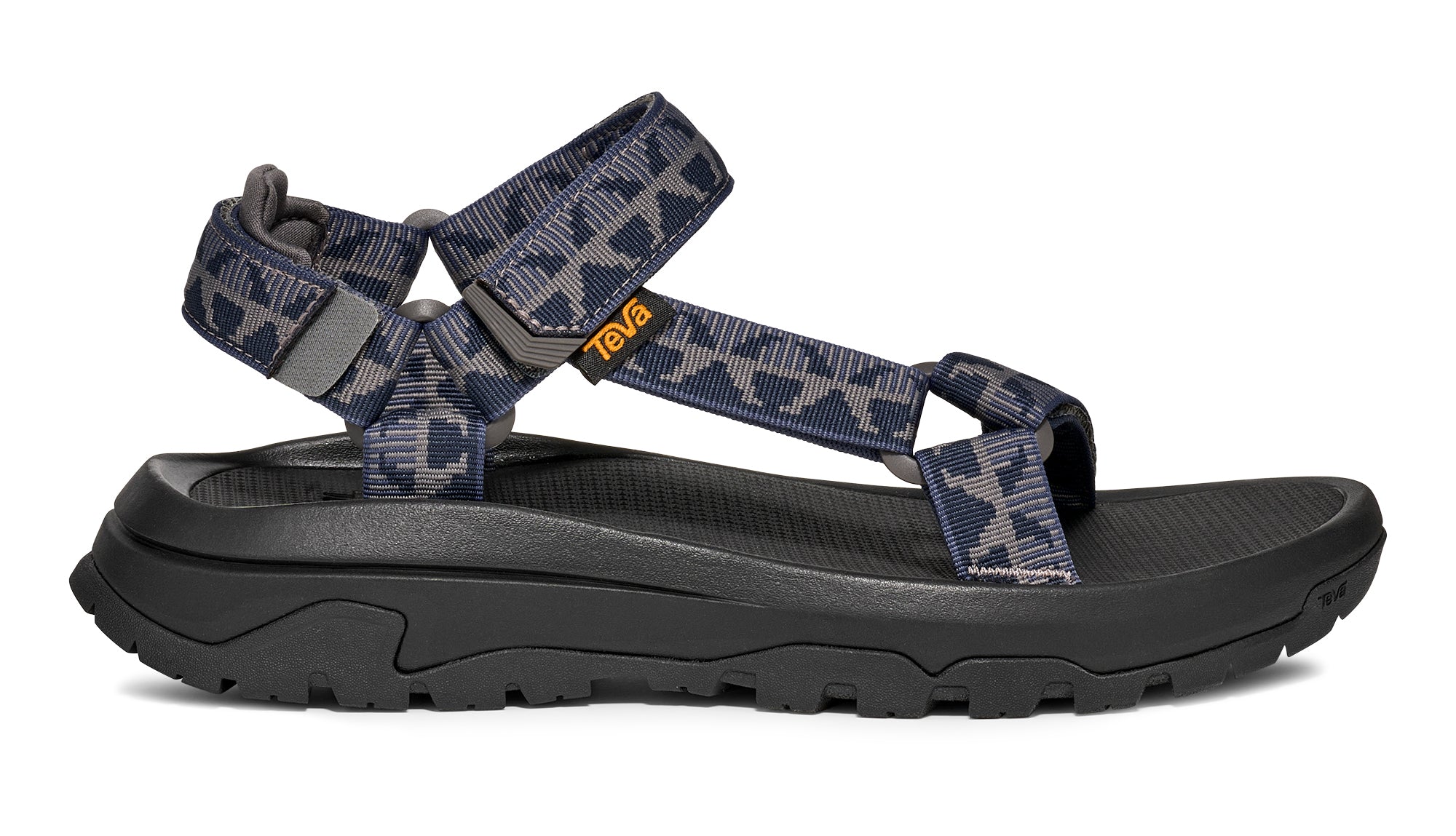 Black sandal with blue patterned straps on a white background
