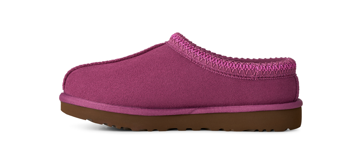 A single magenta pink slip-on clog shoe with a brown sole, shown from a side profile on a white background.