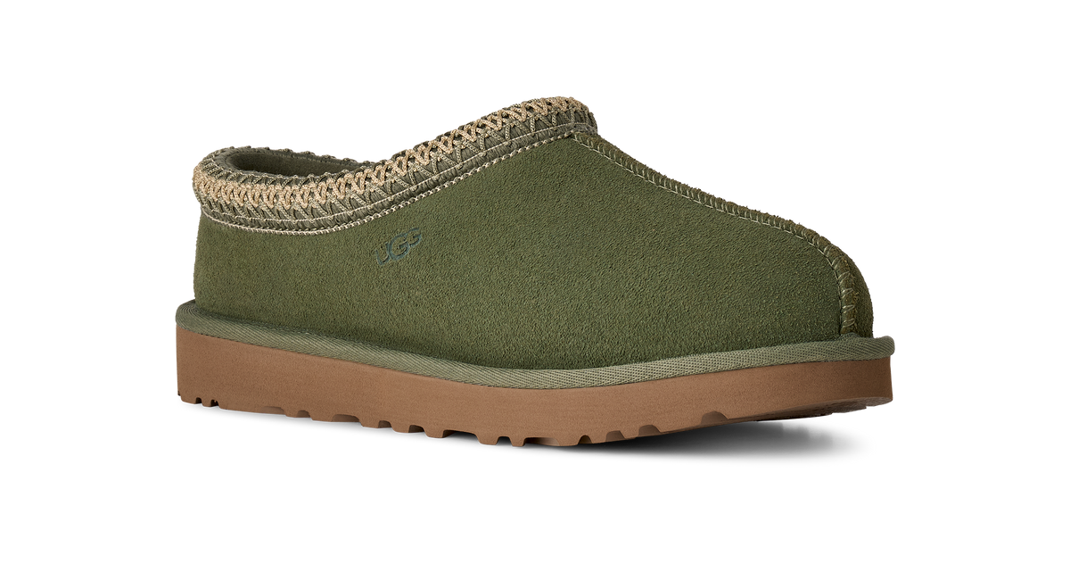 An olive green slip-on clog-style shoe with a tan woven trim around the collar and a brown sole, shown on a plain white background.