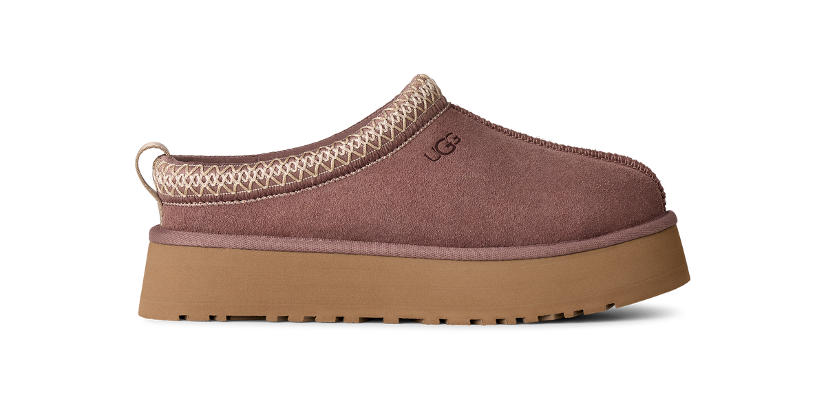 A single UGG slip-on clog shoe in dusty mauve-brown suede with a tan platform sole and a beige braided trim detail, shown from a side profile on a white background.