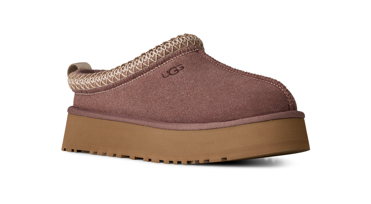Brown slip-on shoe with a platform sole on a white background