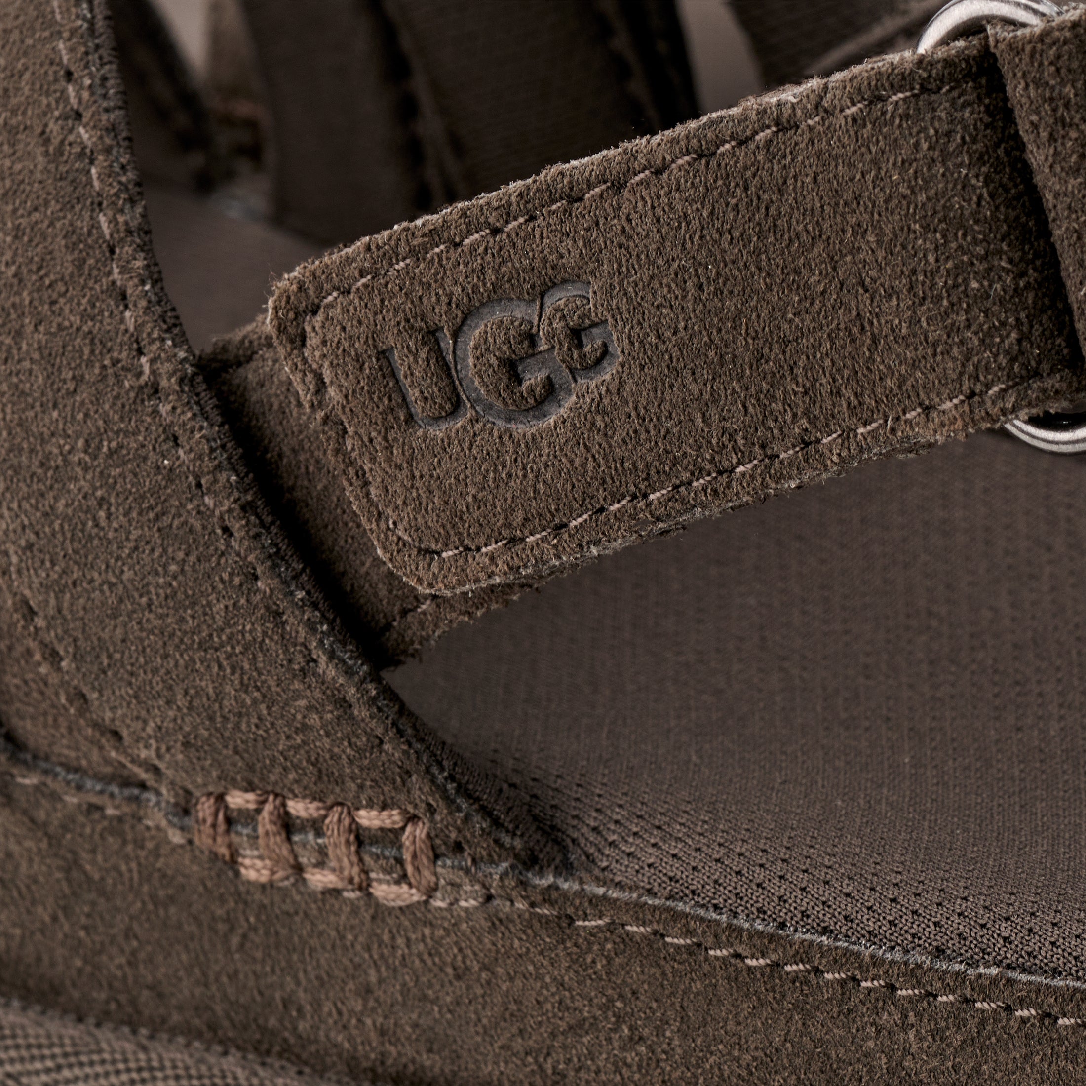 Close-up of a brown UGG boot with brand logo