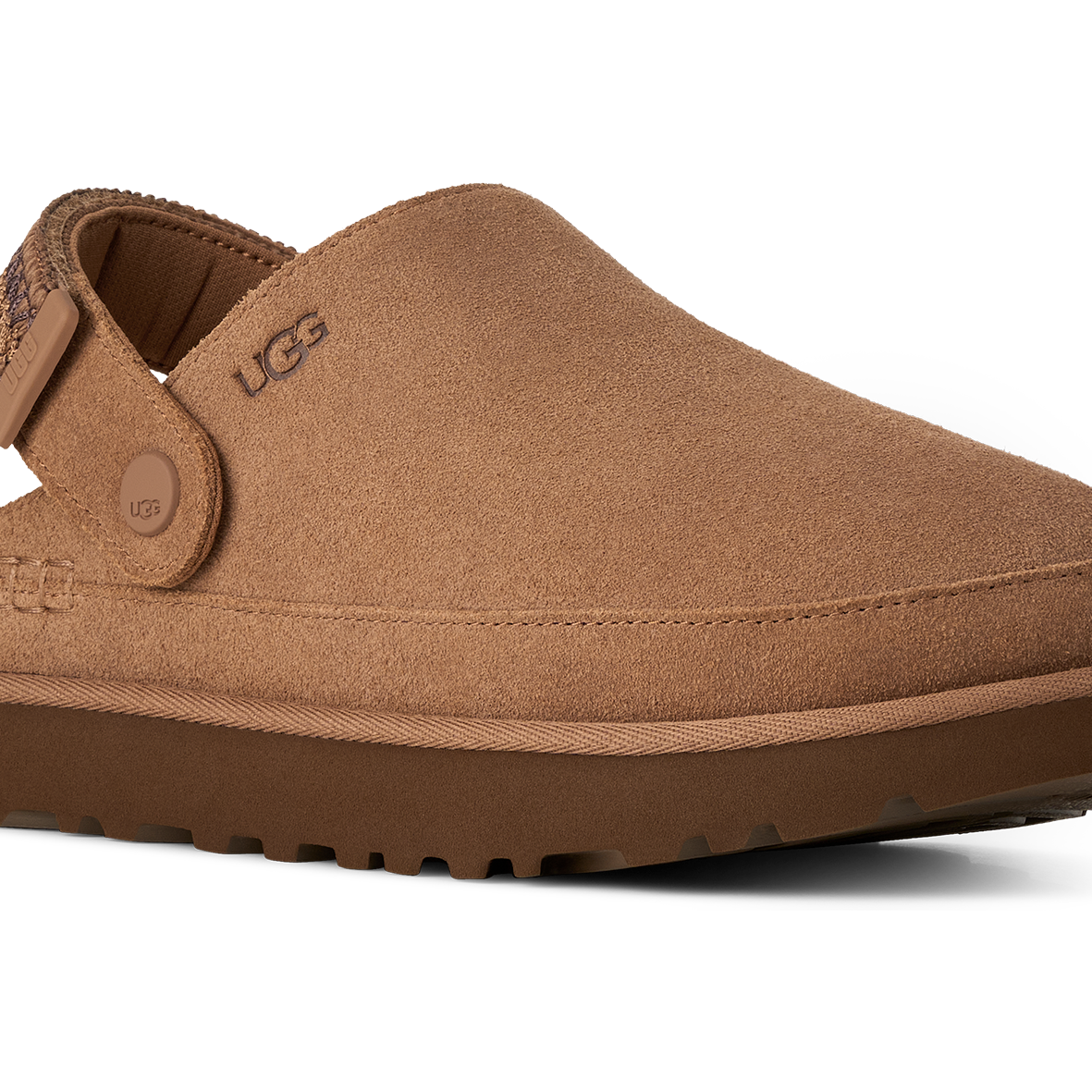 A single UGG slip-on clog shoe in tan suede with a brown sole, shown from a three-quarters angle on a white background.