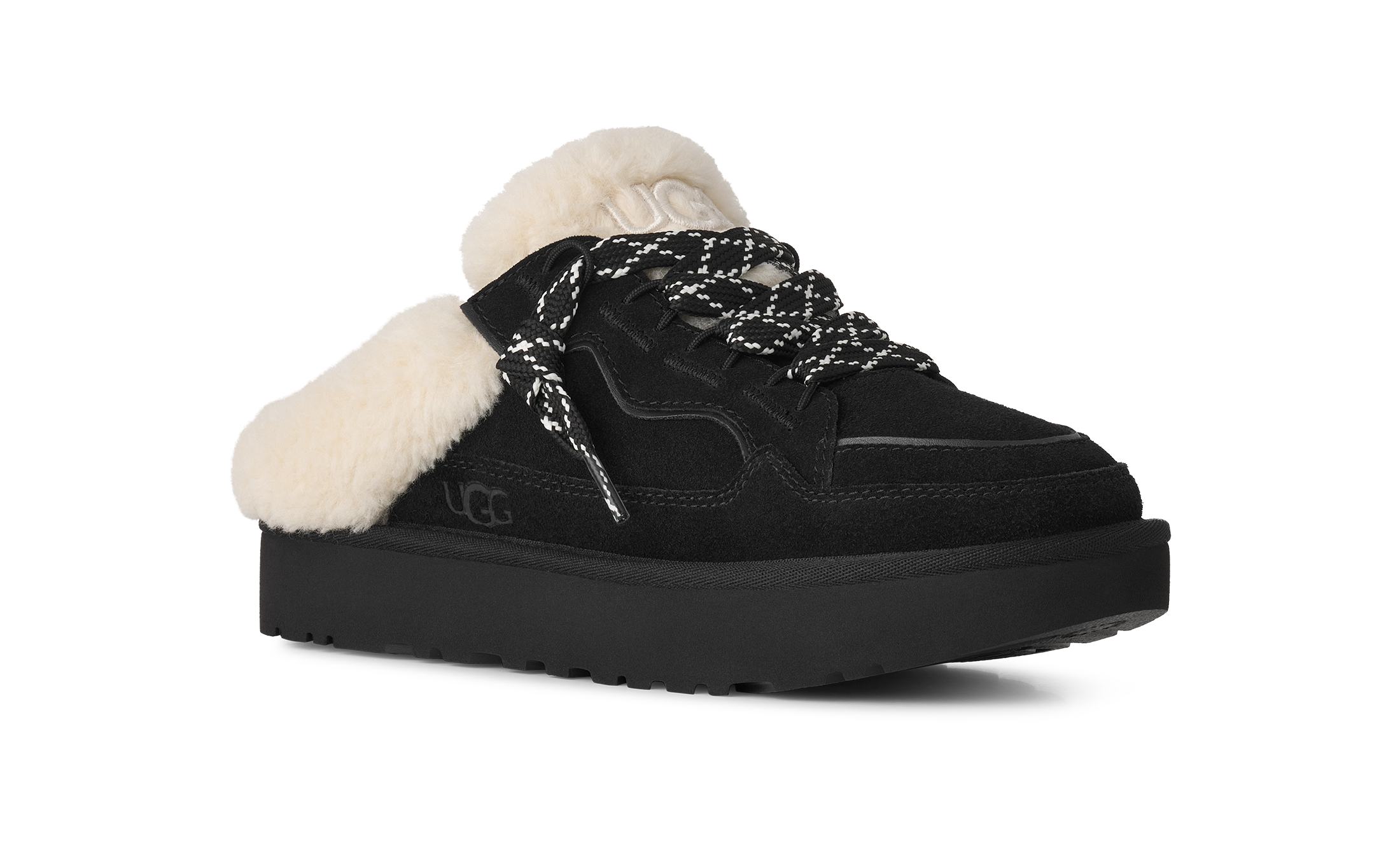 A black UGG platform slipper shoe with fluffy white shearling lining and black-and-white patterned laces, shown from a three-quarters angle on a white background.