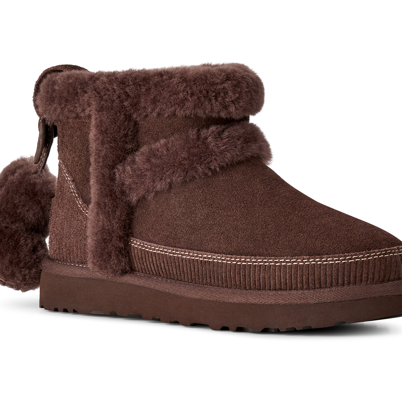 Brown suede boot with fur trim on a white background
