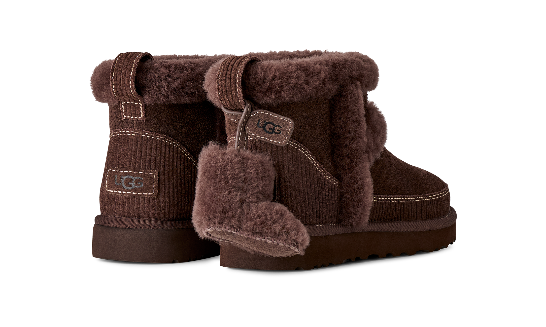 Pair of brown UGG boots with fur trim on a white background