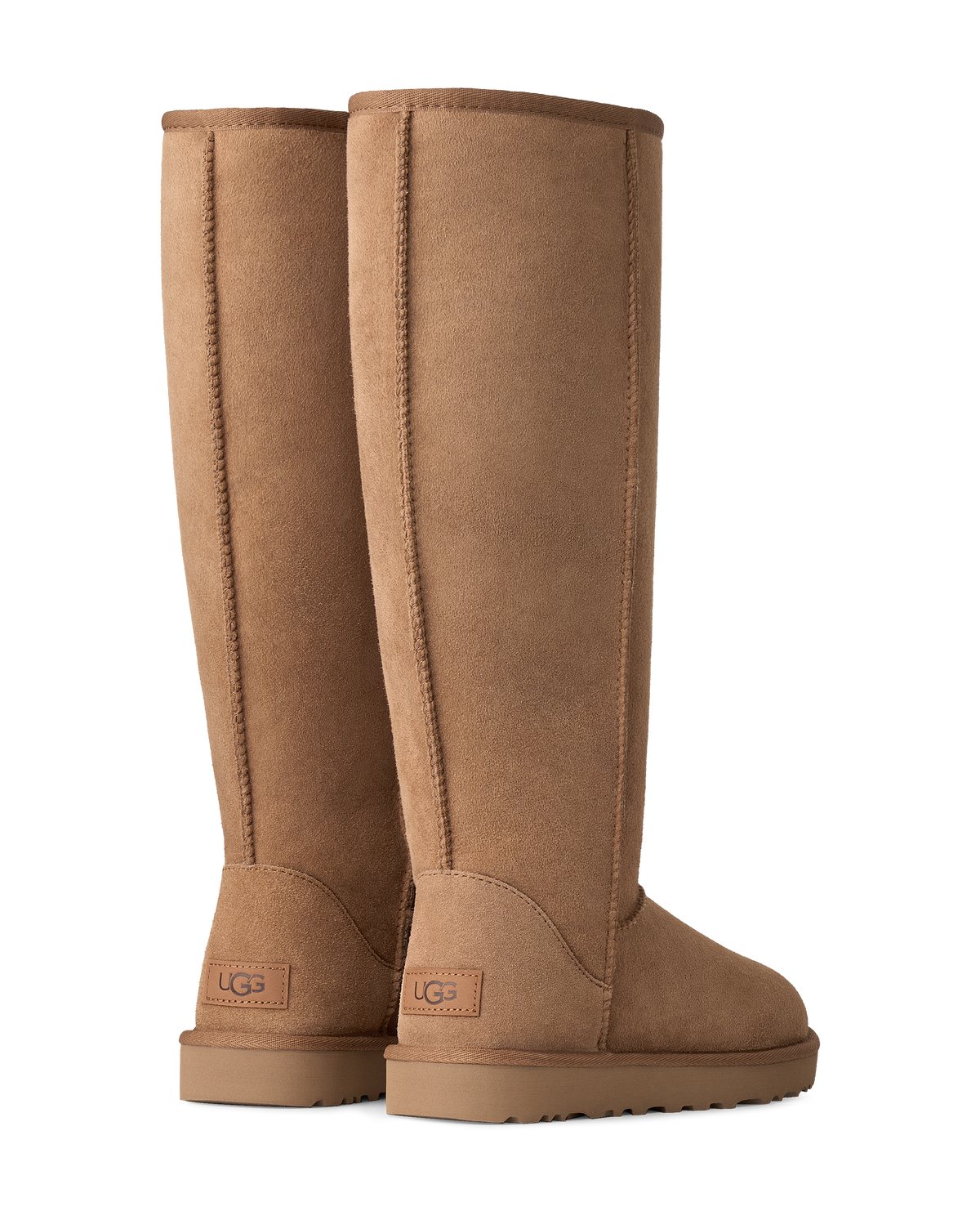 A pair of tall, knee-high UGG boots in a warm tan suede finish, shown from the back on a clean white background.