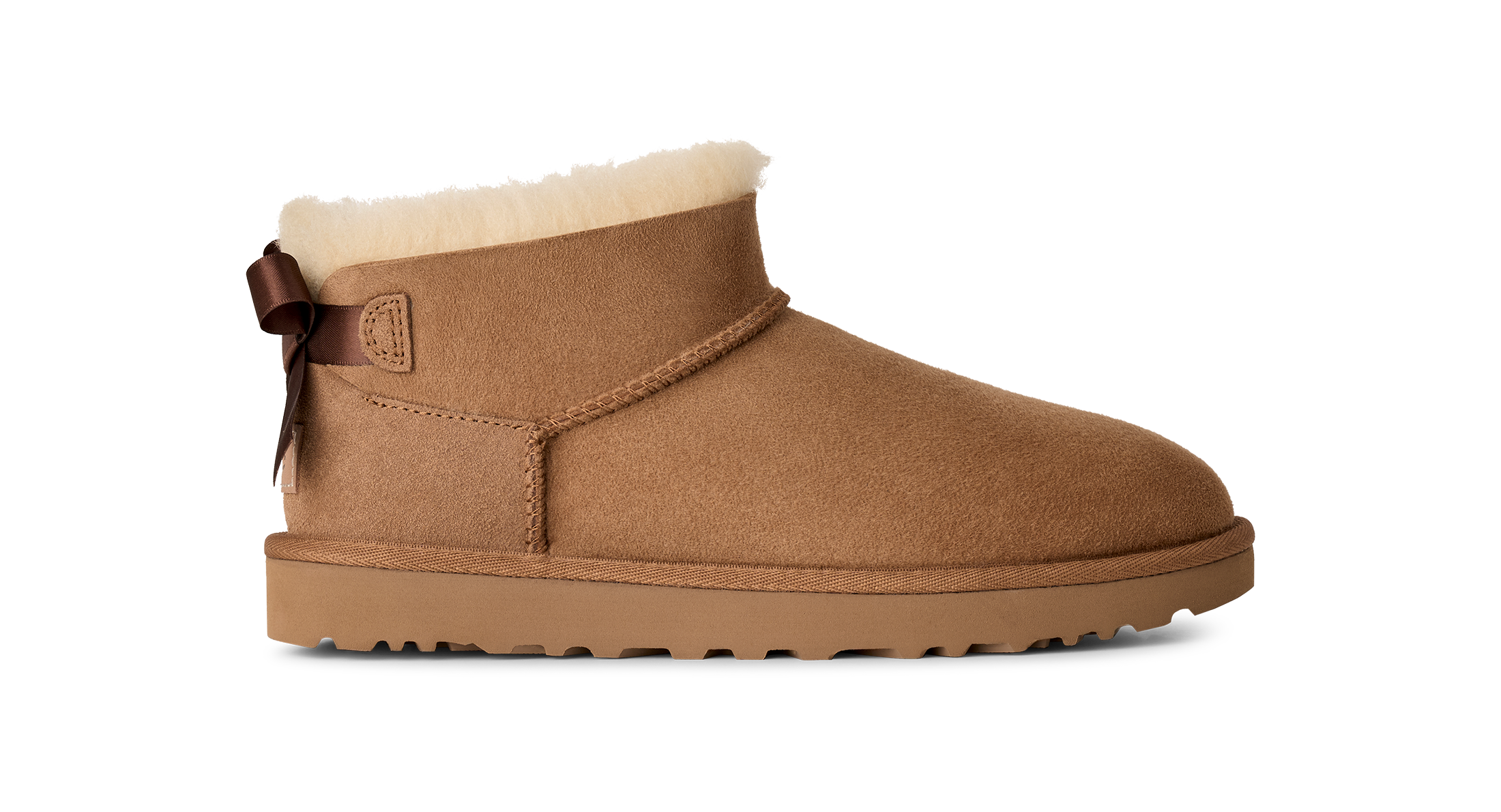Brown suede boot with white fur lining on a white background
