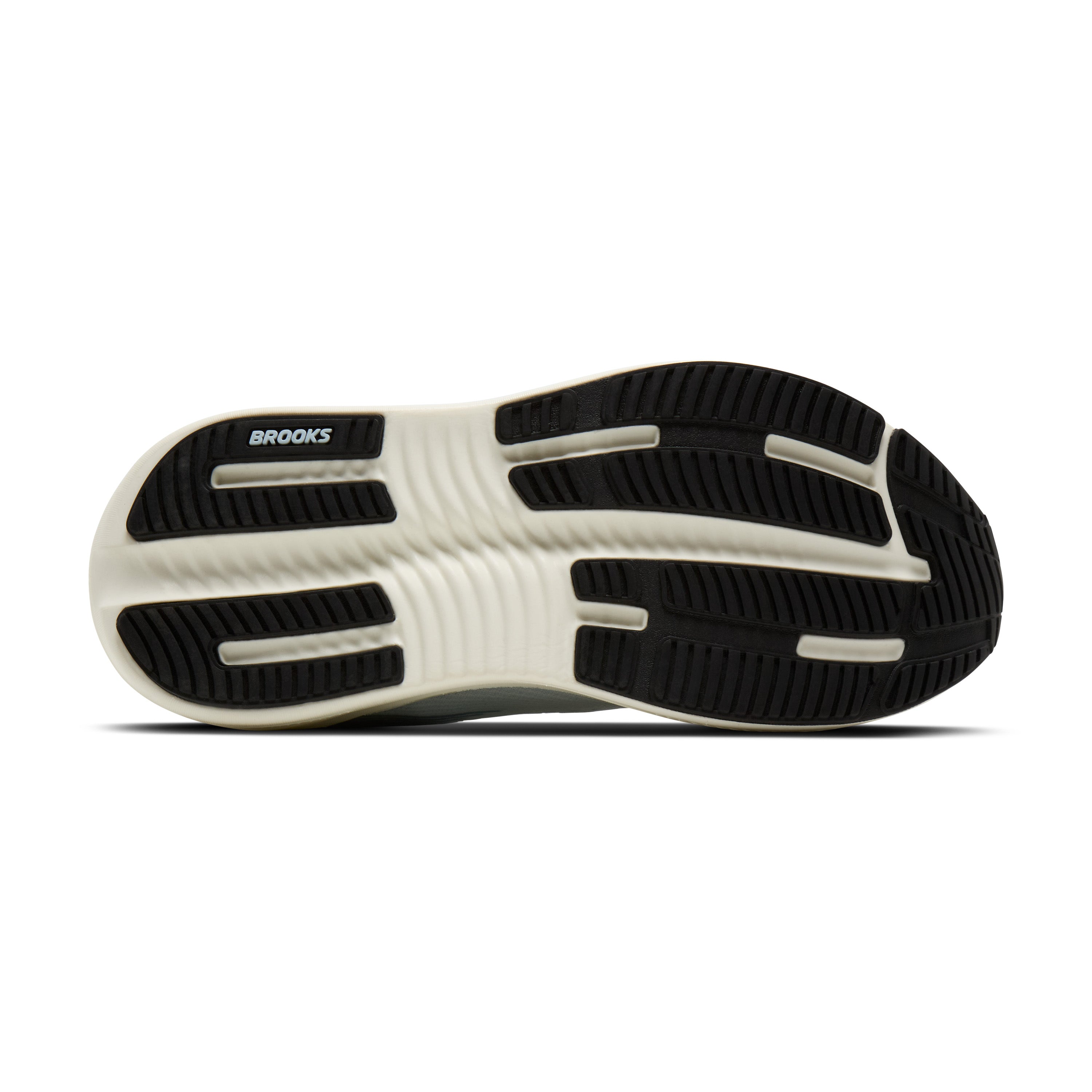 The outsole of a Brooks running shoe, showing a black treaded bottom with a white midsole and the BROOKS logo printed in black on the heel.