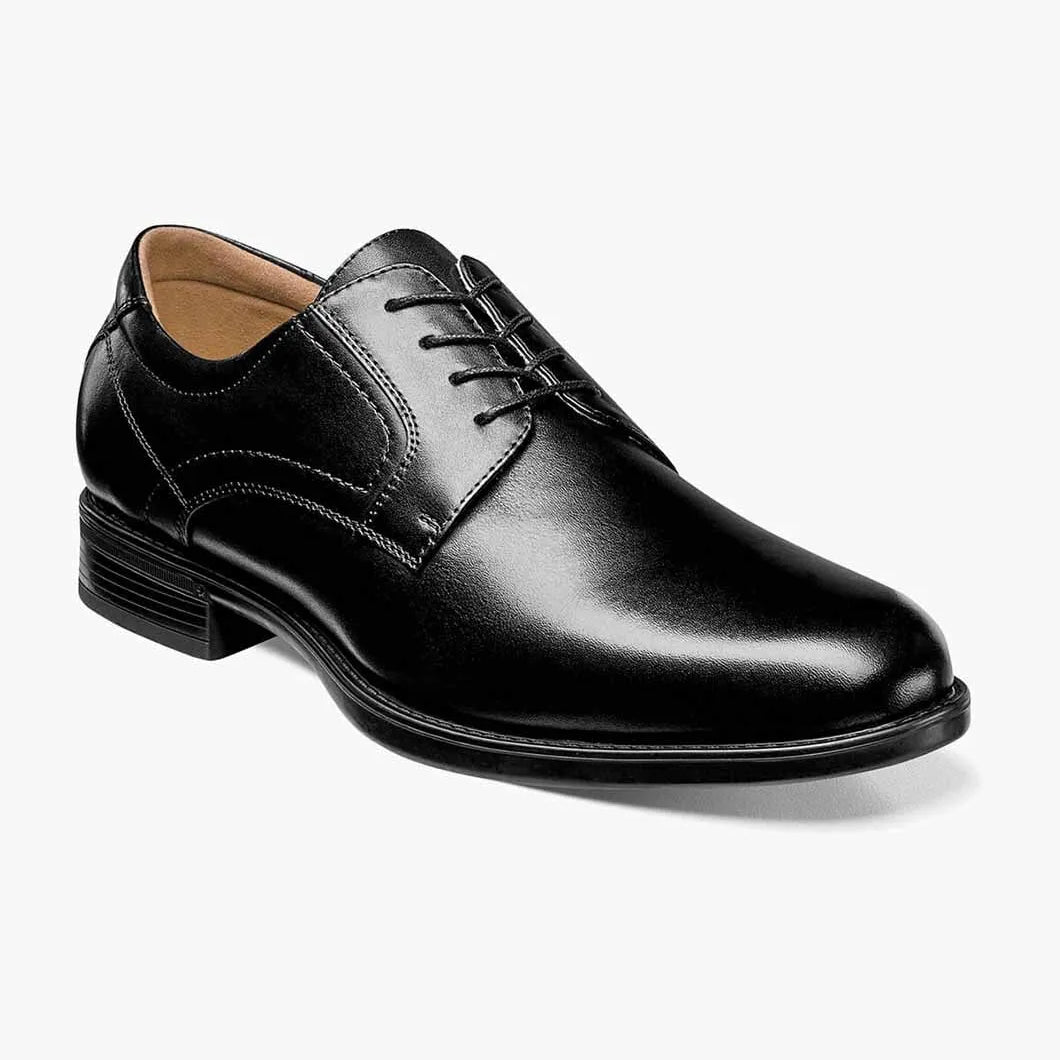 Black leather dress shoe on a white background