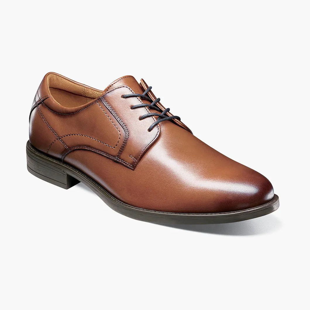Brown leather dress shoe on a white background