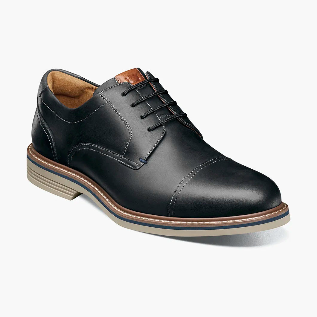Black leather dress shoe on a white background
