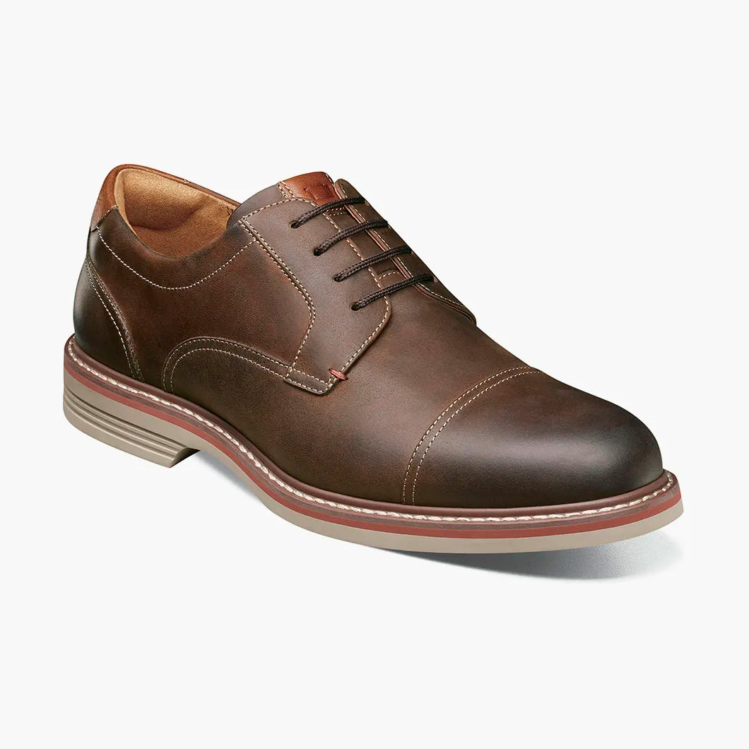 Brown leather dress shoe on a white background