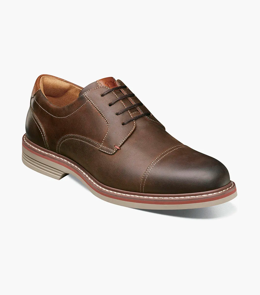 Brown leather dress shoe on a white background