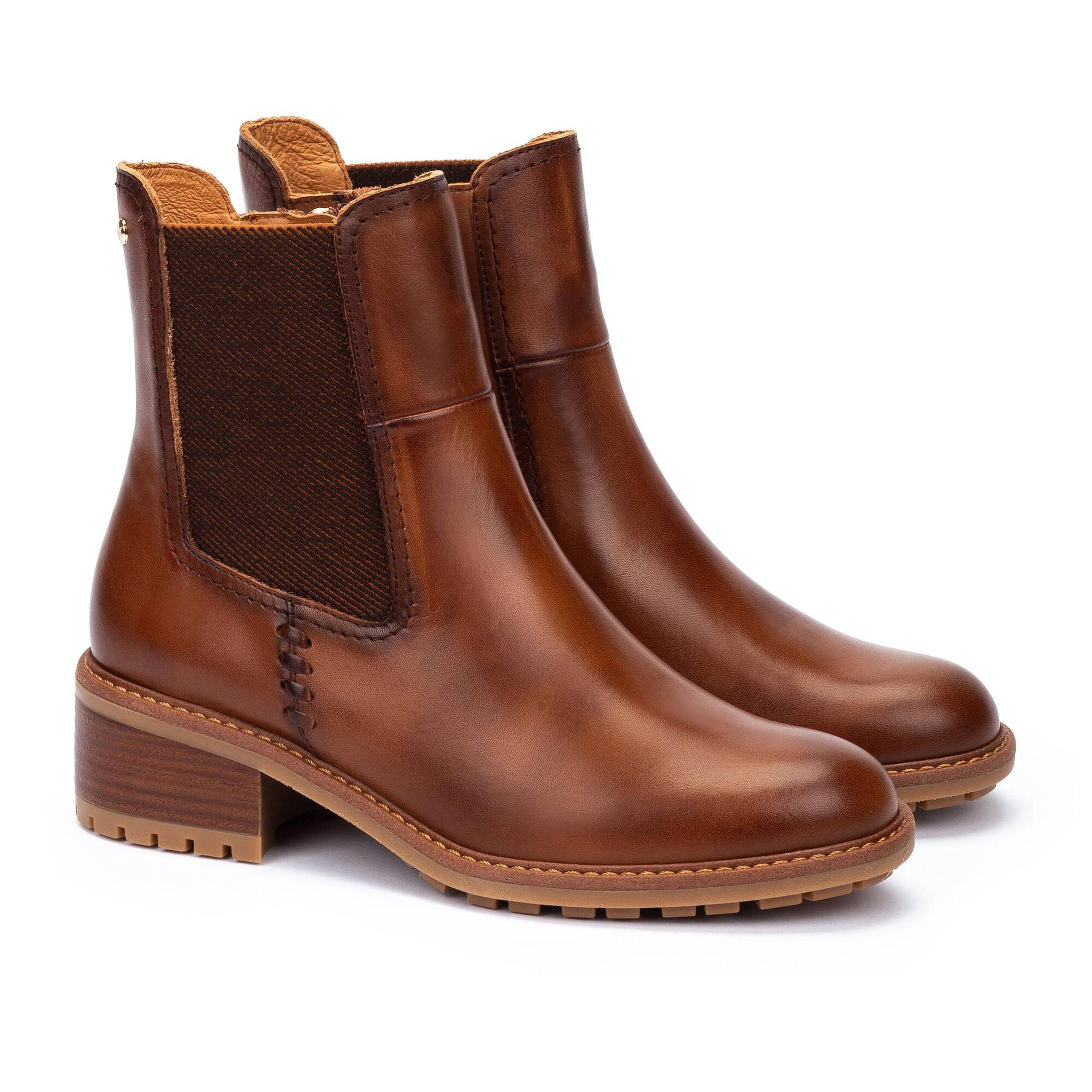Pair of brown leather boots on a white background