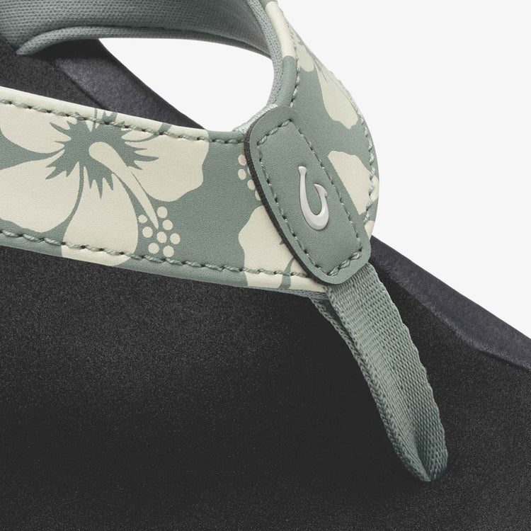 Close-up of a gray strap with floral pattern on a black background
